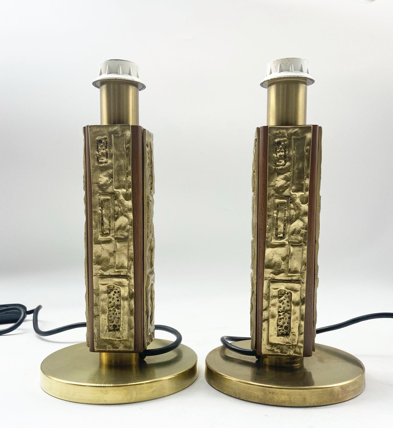 Pair of table lamps in wood and worked brass, of Italian production, the workmanship and style are by the artist Angelo Brotto who designed them for the Esperia Italia company in the 1960s.