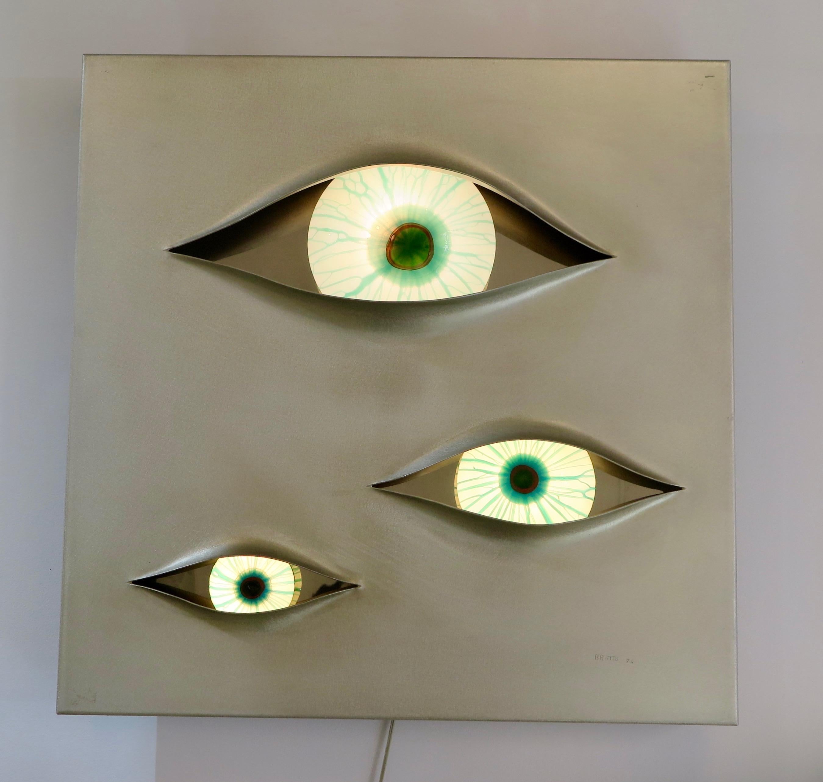 Illuminated wall light panel in brushed stainless steel and 3 eyes in painted 