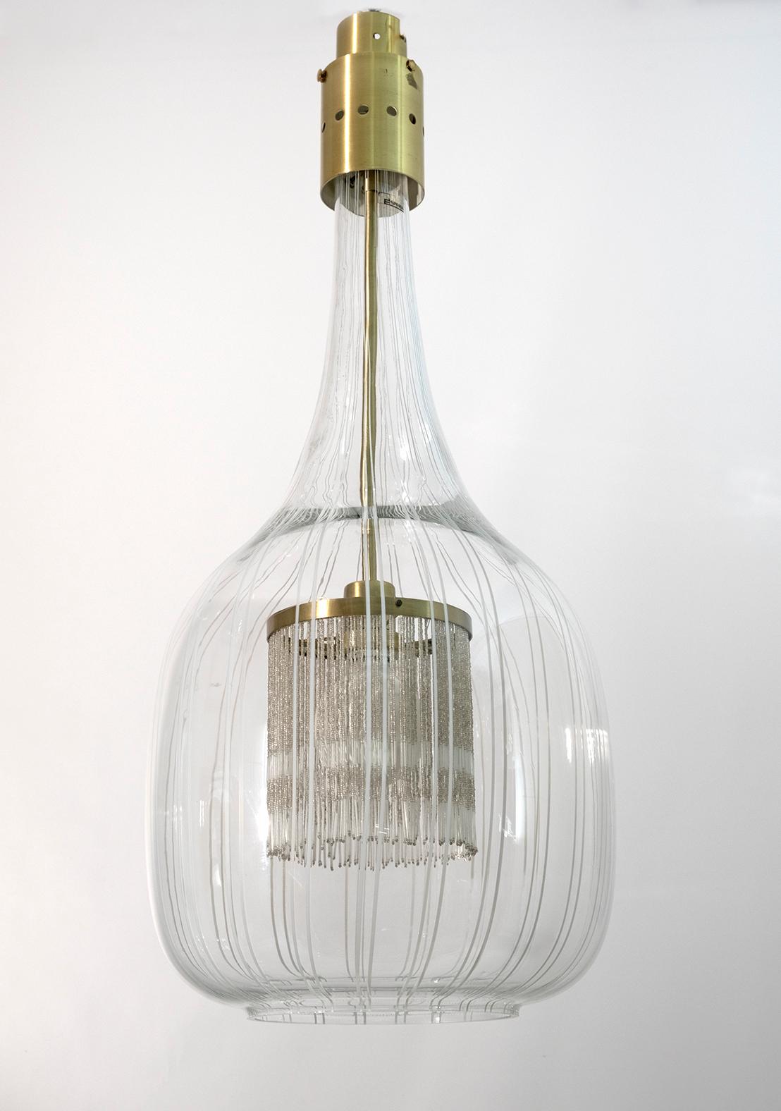 Angelo Brotto for Esperia, pendant lamp, glass, brass, Italy, 1970s

Angelo Brotto's design is elegant in every sense. A glass latern decorated with vertical lines hangs on a brass fixation. Mouth-blown Murano glass shows true craftsmanship. On a