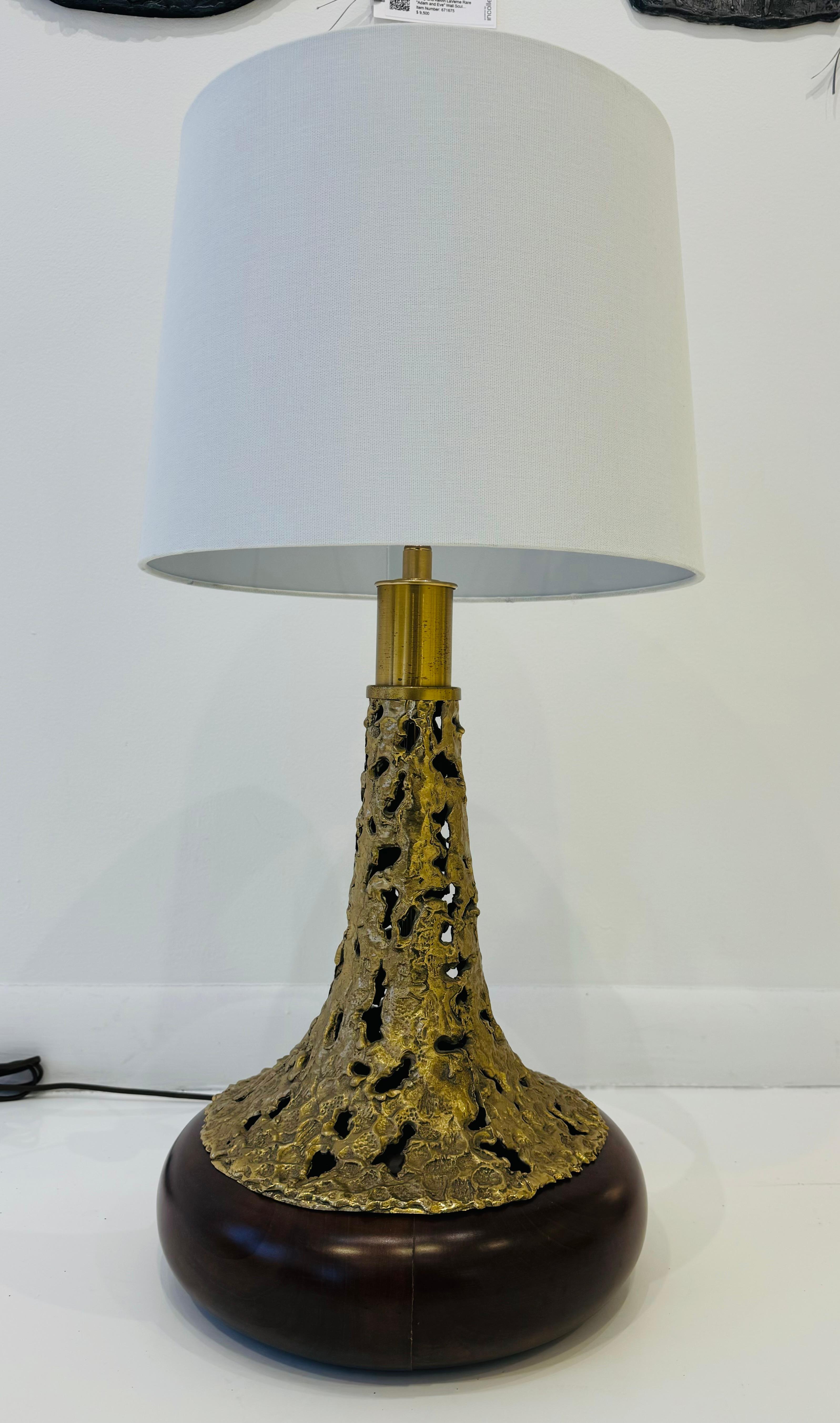 A sculptural brutal designed bronze and walnut table lamp by famed Italian artist, Angelo Brotto. Newly Rewired with double brass standard sockets and silk cord. 