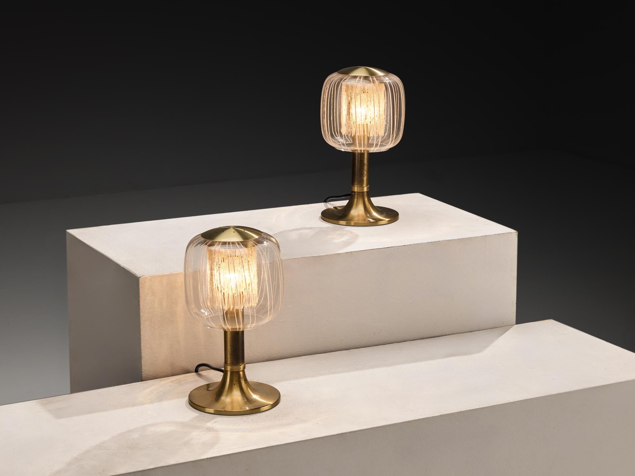 Angelo Brotto for Esperia table lamps, brass, glass, Italy, 1970s

These table lamps, designed by Angelo Brotto in the 1970s, reflects the elegance of Italian design from the period. Each piece features a brass stem and base, creating a refined
