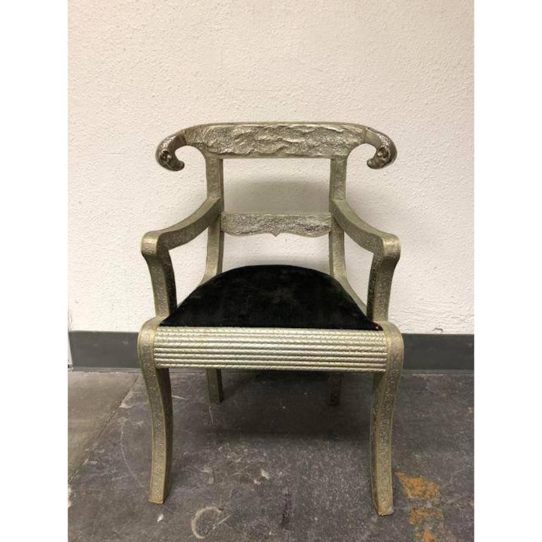 A Angelo-Indian Dowry rams head armchair. A lovely vintage wedding chair, covered in floral embossed silver metal. The seating is upholstered in a black velvet. Measure: Armheight 24 inches, seat height 18 inches.

 