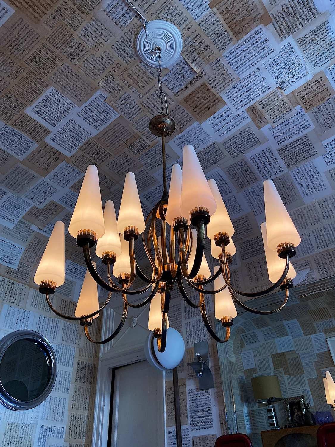 Exceptional big brass extra large chandelier designed by Angelo Lelii for Arredoluce. The chandelier base is in brass with sixteen Murano glass cones.