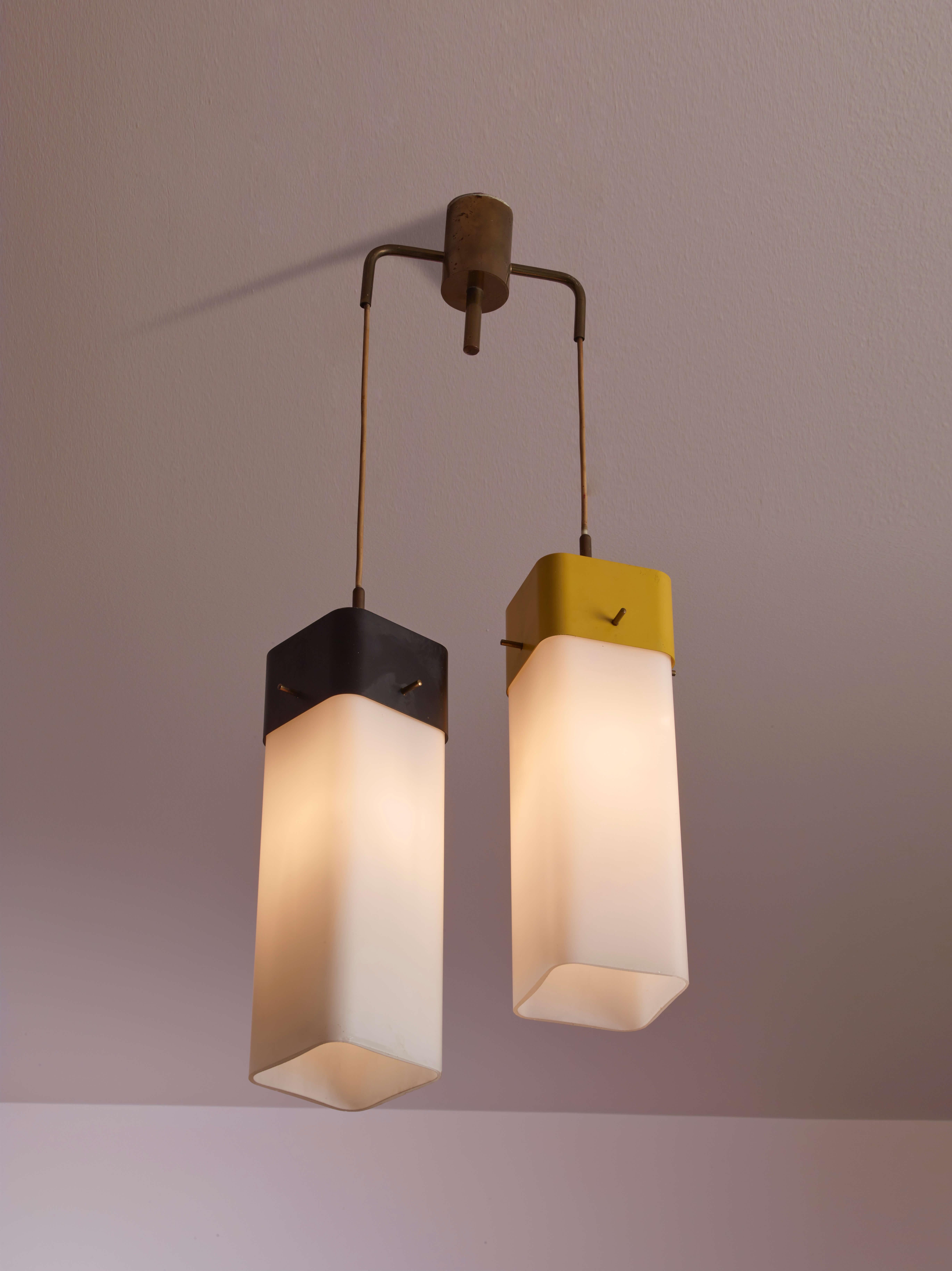 Suspension lamp with two diffusers made of brass, painted metal, and opaline glass, produced by Arredoluce and designed by Angelo Lelii in 1957.

Simple and geometric, this pendant lamp designed by Angelo Lelii in 1957 captures the style of the era.
