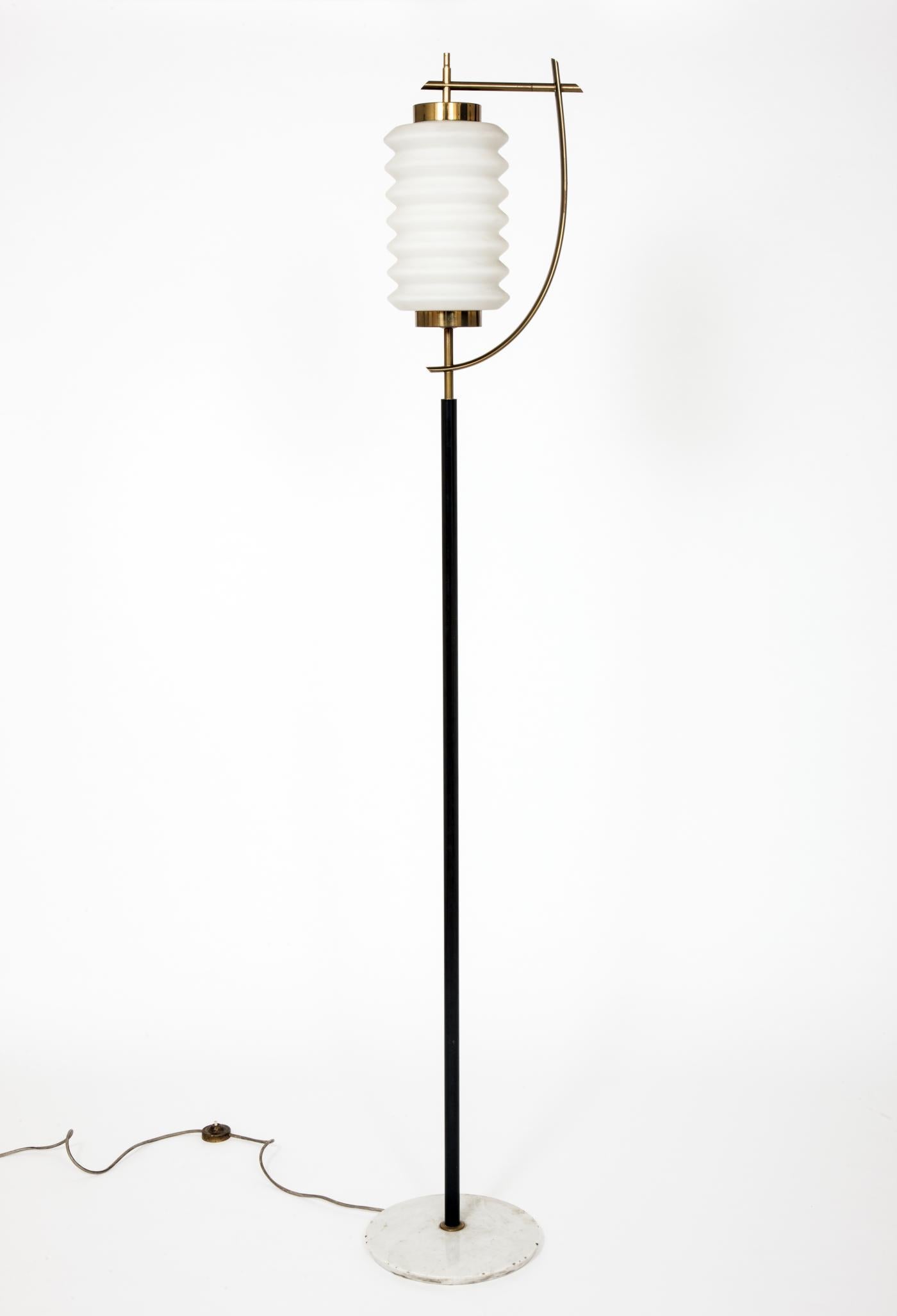 A rare floor lamp by Angelo Lelii for Arredoluce designed in 1959.
Enameled metal stem with brass structure and white glass diffuser rests on a white and grey veined marble base.
 