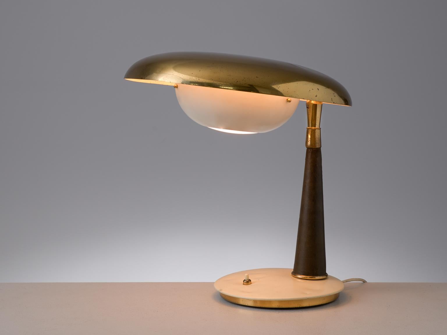 Angelo Lelii for Arredoluce, table lamp, in brass, metal and leather, by Italy, 1950s. 

Stylish desk light with admirable patinated brass shade, designed by Italian designer Angelo Lelli. The disc-shaped shade has an opposite shade as diffuser. The