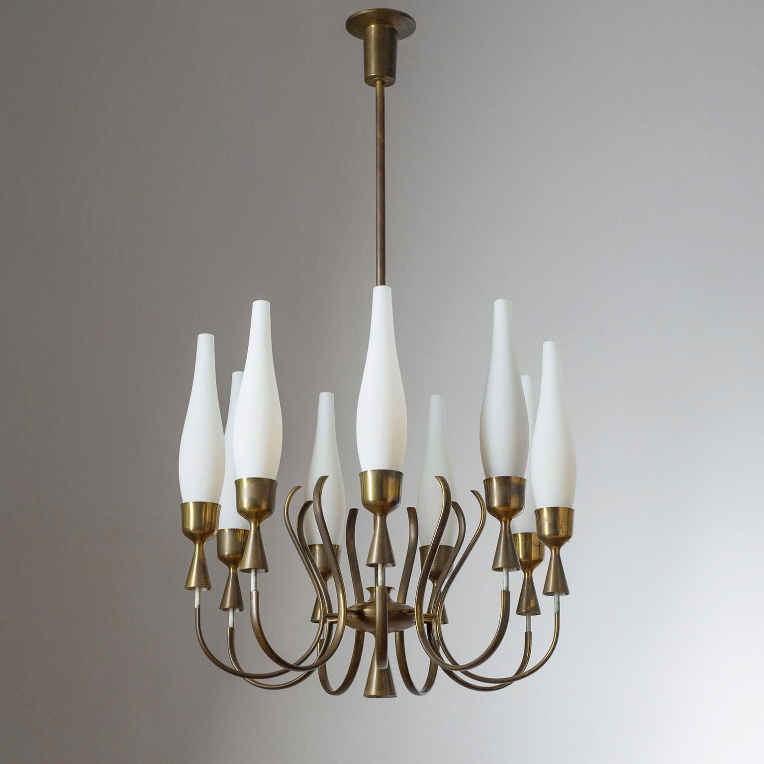 Rare nine-arm brass chandelier by Angelo Lelii for Arredoluce, 1957. Exquisitely curved arms with seemingly floating socket covers and slender satin glass diffusers. Dark patina on the brass and off-white lacquered elements.
Literature: