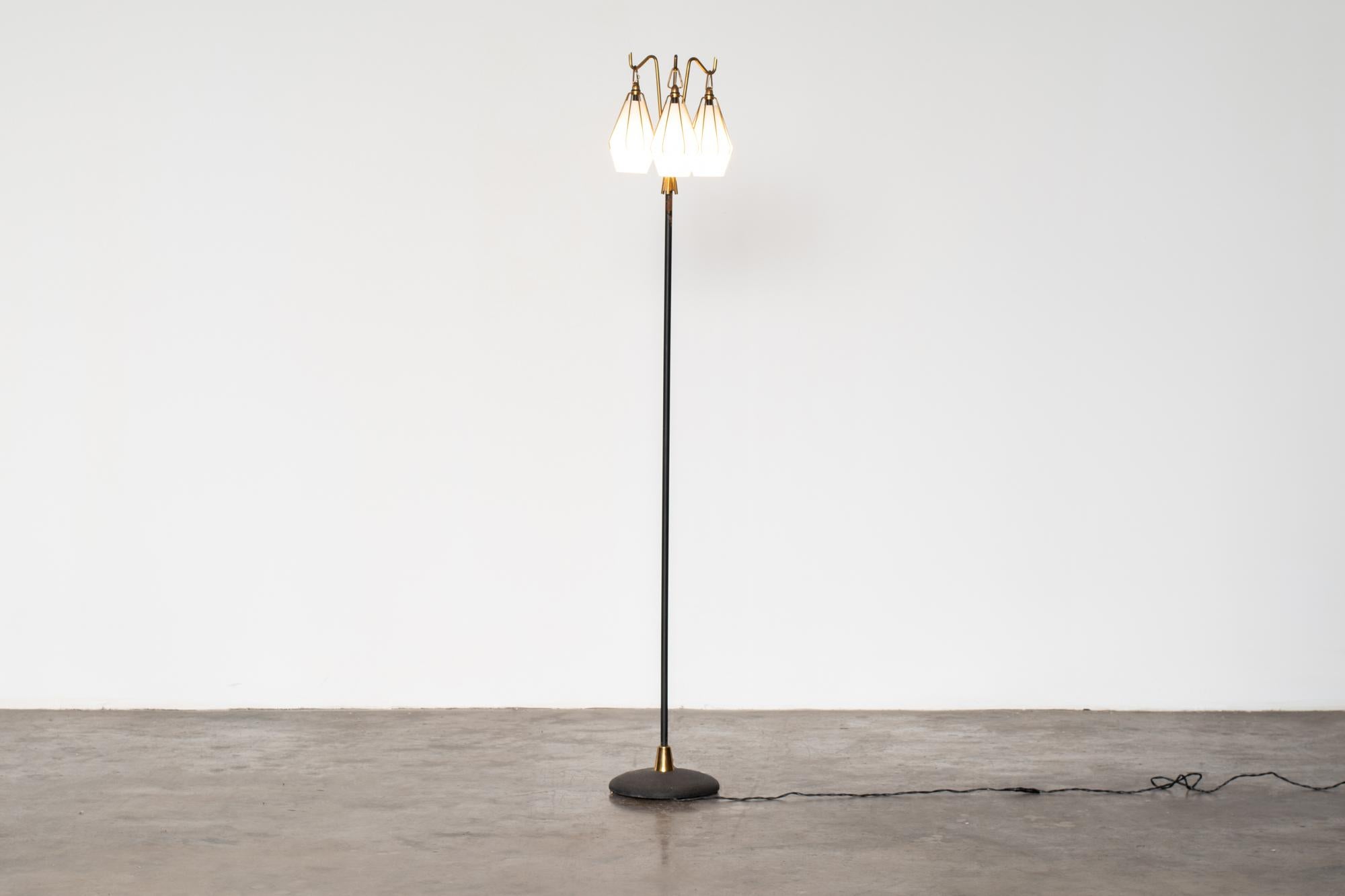 Floor lamp with three glass lampshades, designed by Angelo Lelii for Arredoluce, 1950s.
This lamp presents a painted metal structure with lampshades in satin glass and brass details.
Manufacturer's brand stamped under the base of the lamp.