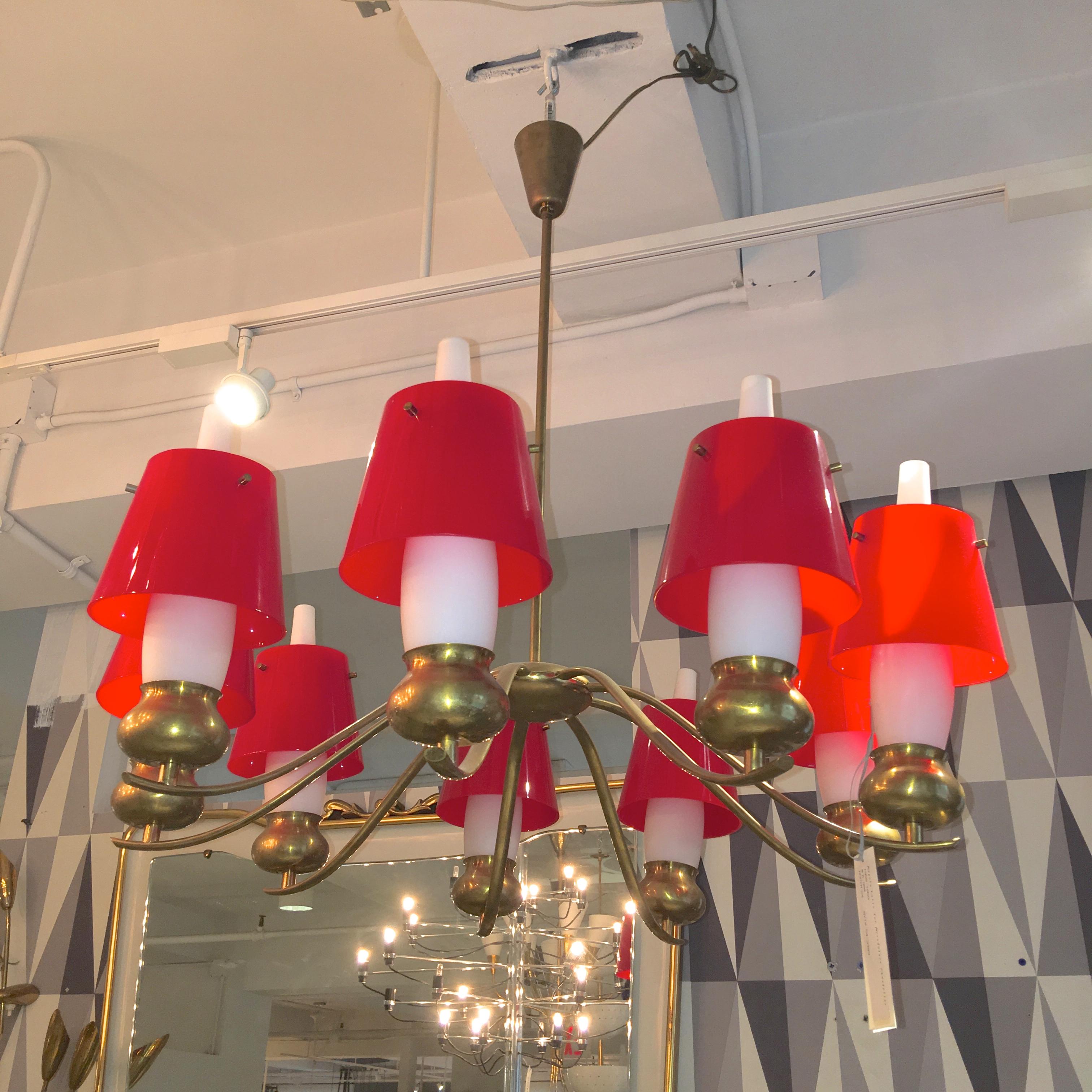 Ddesigned by Angelo Lelli and produced by Arredoluce Monza in 1959. Nine scrolled brass arms with brass bun shaped lamp holders with original white opaline glass chimney shades, further embellished by original flared plexi acrylic shades which slip