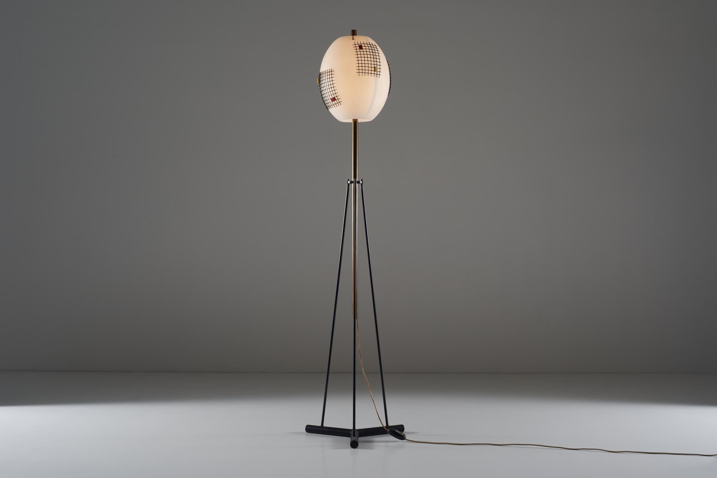 This rare floor lamp fills the space elegantly and aesthetically satisfying. The triple support gives stability to a structure stretched upwards, towards an opal glass globe enriched with metal and plexiglass decorations. The aesthetic taste of