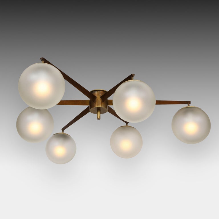 Angelo Lelli for Arredoluce rare original Stella flush mount ceiling light or chandelier with six acid-etched glass globe shades suspended from rich patinated brass structure and mount. This particular model in this configuration is very rare -