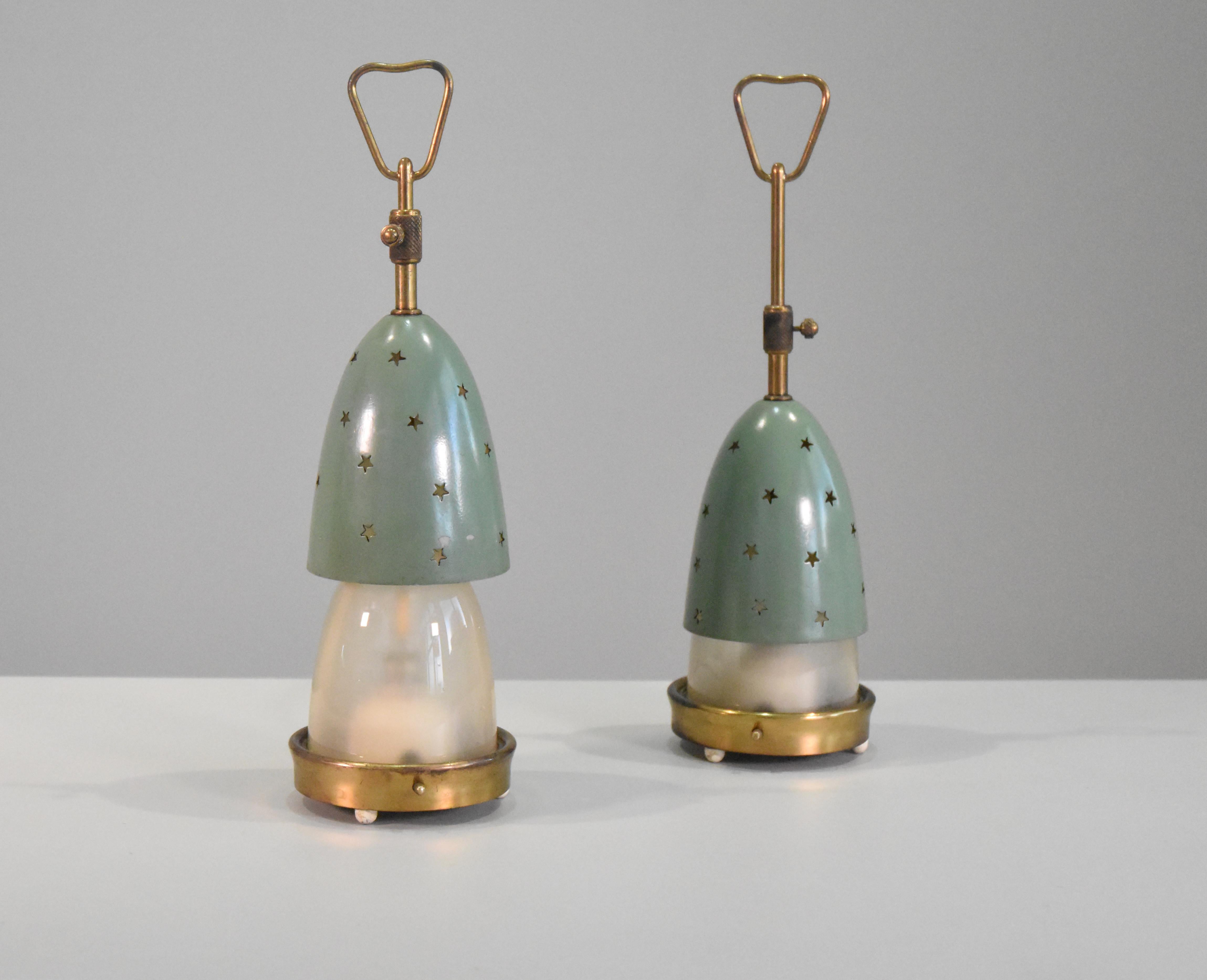 Pair of table lamps Stelline lamps  12291 model designed by Angelo Lelii for Arredoluce, Italy, 1950s. 
Lamps have a brass structure and a double shade in frosted opaline glass and metal. 
The outer shadow has a die-cut star pattern.
 The outer