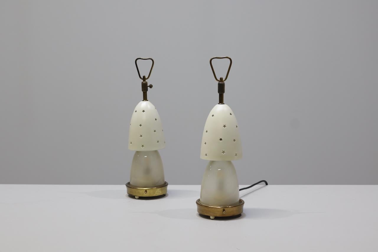 Paire de lampes de table Stelline  modèle 12291 conçu par Angelo Lelii pour Arredoluce, Italie, années 1950. 
Les lampes ont un cadre en laiton et un double abat-jour en verre opalin dépoli et en métal. 
L'ombre extérieure est ornée d'un motif