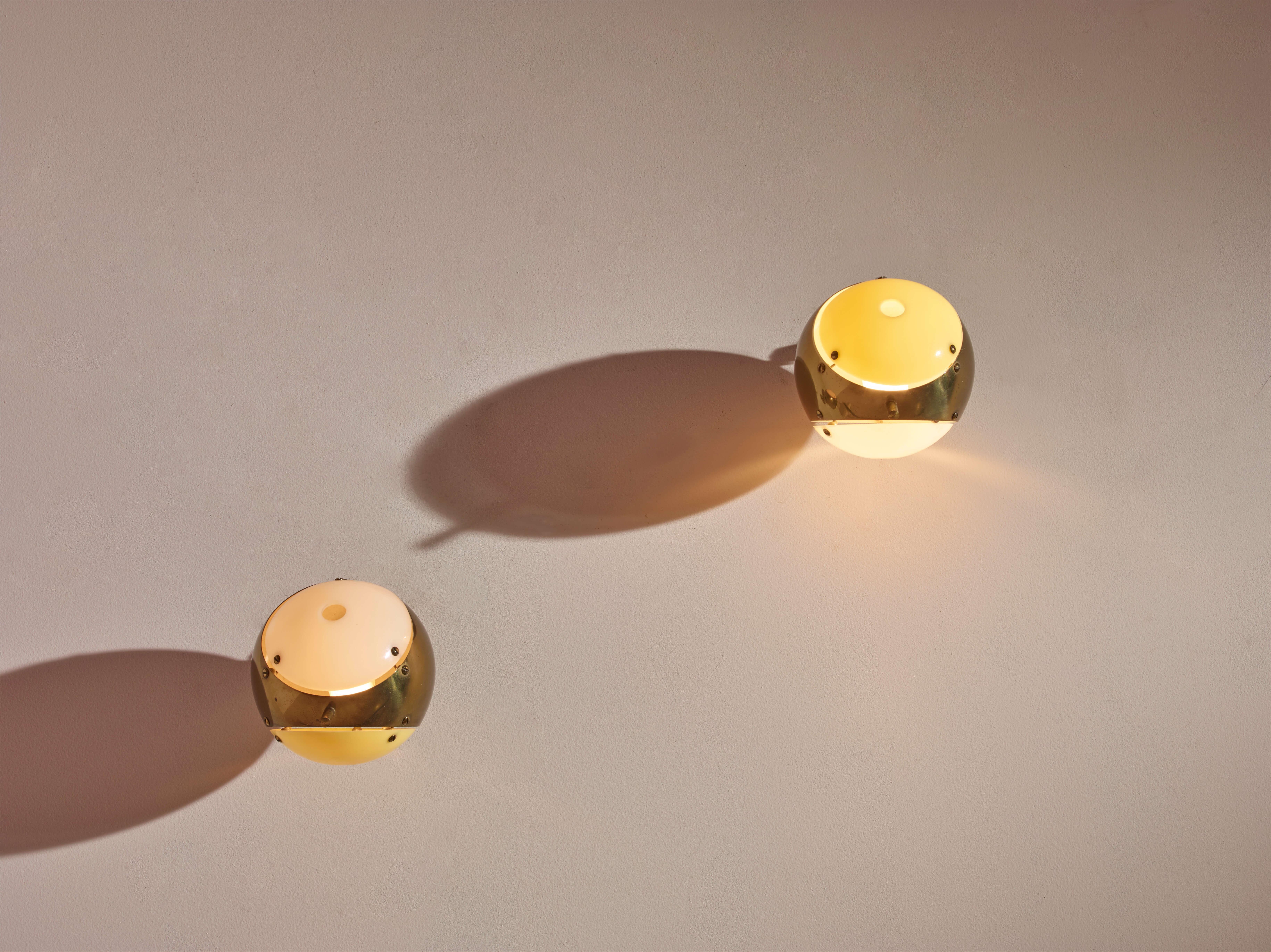 Ein Paar Wandleuchten aus Metall, Messing und Plexiglas, hergestellt in den 1950er Jahren von Arredoluce, entworfen von Angelo Lelii.

Es handelt sich um zwei kleine, an der Wand aufgehängte Kugeln, bei denen die polierte Messingoberfläche in