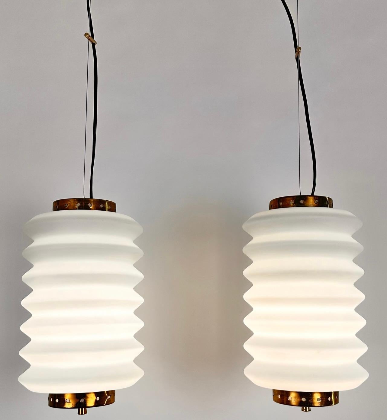 An entirely original pair of  12795 model ceiling lamps designed by Angelo Lelii and edited by Arredoluce in 1959..Structure in polished brass ,diffuser in duplex white opal glass..Excellent condition.
Free  packing and