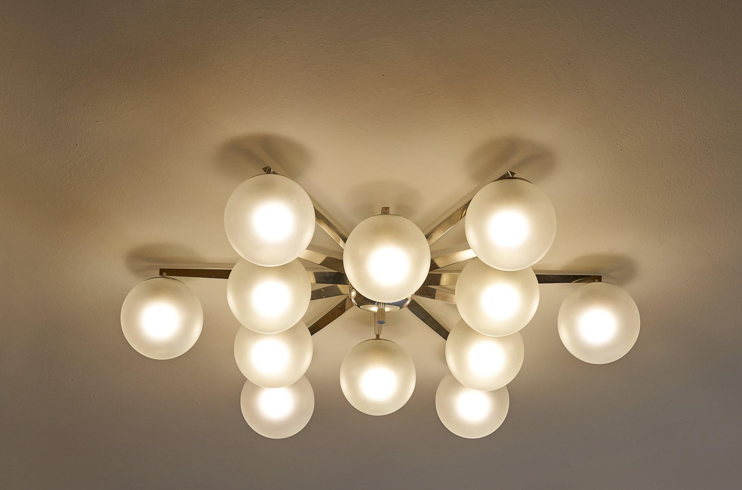 Angelo Lelii
Large Stella chandelier for Arredoluce Monza
Italy 1950s
Nickel-plated metal, nickel-plated brass, frosted glass
Measures: 8.75 height × 51.5 diameter in

Signed with applied manufacturer's label to the inside ceiling canopy.