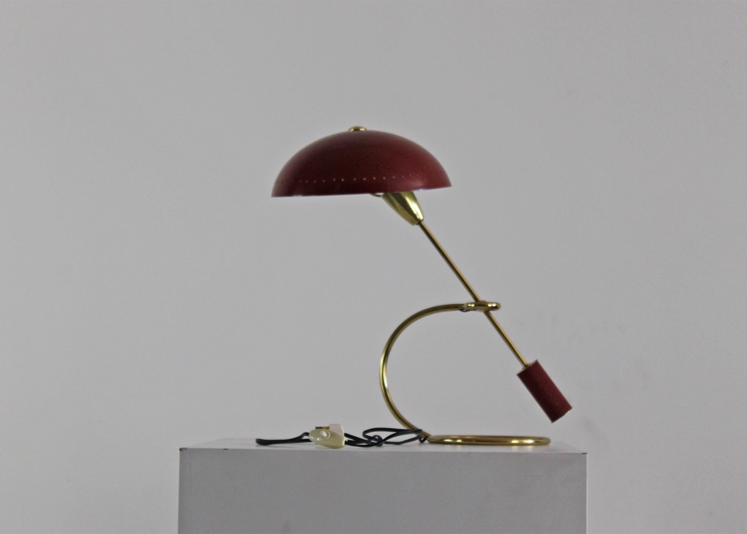 Lampada da tavolo con struttura in ottone e paralume in alluminio verniciato di rosso disegnata da Angelo Lelii, manifattura italiana anni '50.

Licterature: Domus n.288, novembre 1953, p. 35; C. & P. Fiell, 1000 luci
Dal 1878 al 1959, Taschren,