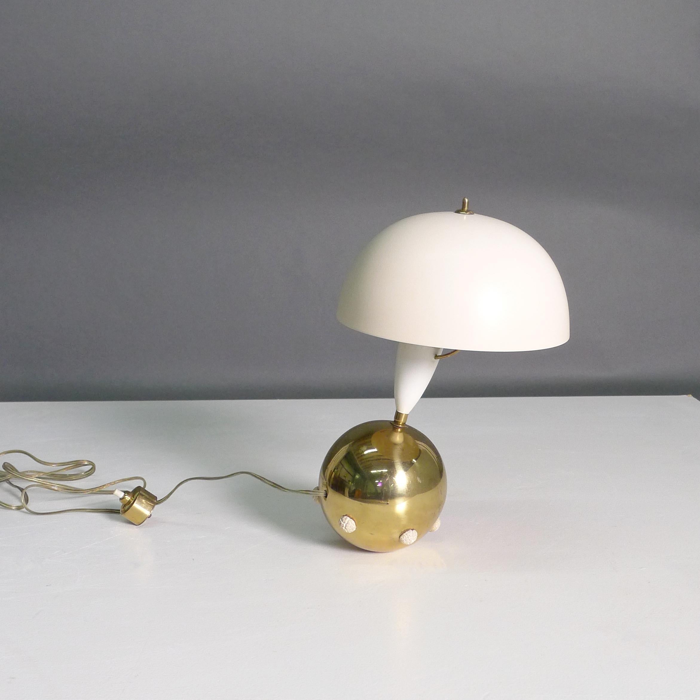 Angelo Lelii for Arredoluce, Italy

Model 12405 table lamp, designed 1952 and manufactured throughout the 1950s.  With cream lacquered aluminium reflector on a spherical base in polished brass with rubber studs, the push button in cast brass. 