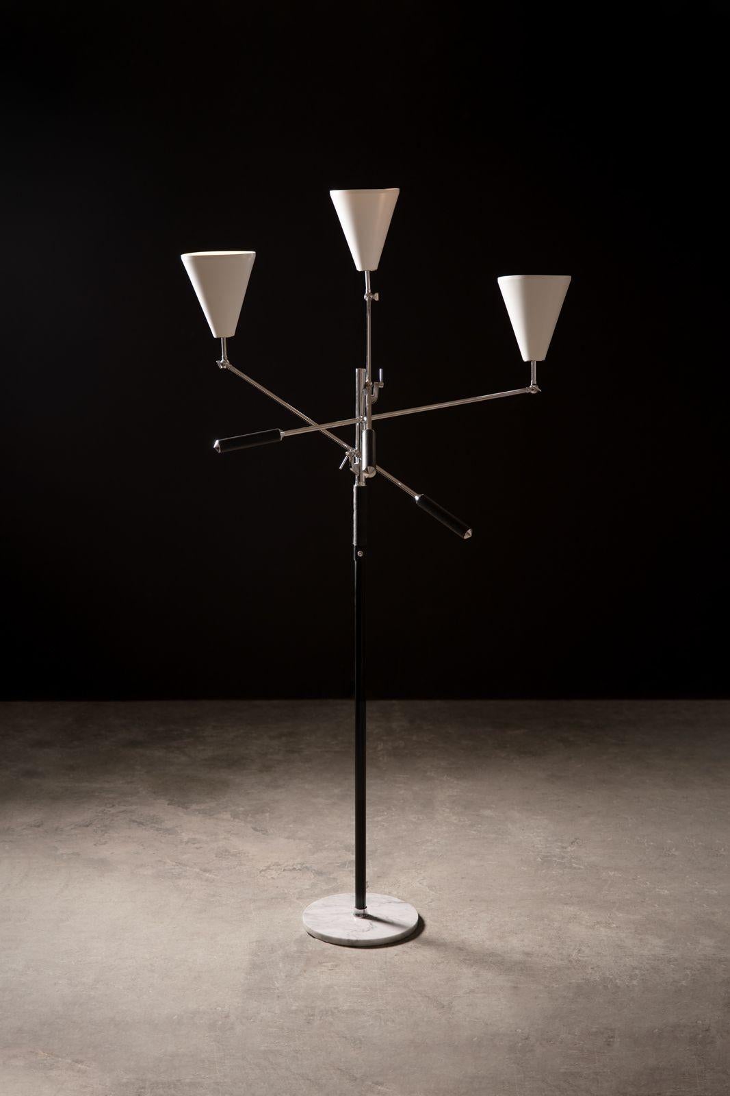 ARREDOLUCE Triennale floor lamp was designed by Angelo Lelii and manufactured in Monza, Italy in the 1960s. Constructed of nickeled brass, enameled steel and aluminum, leather, marble, and three sockets. Stamped 