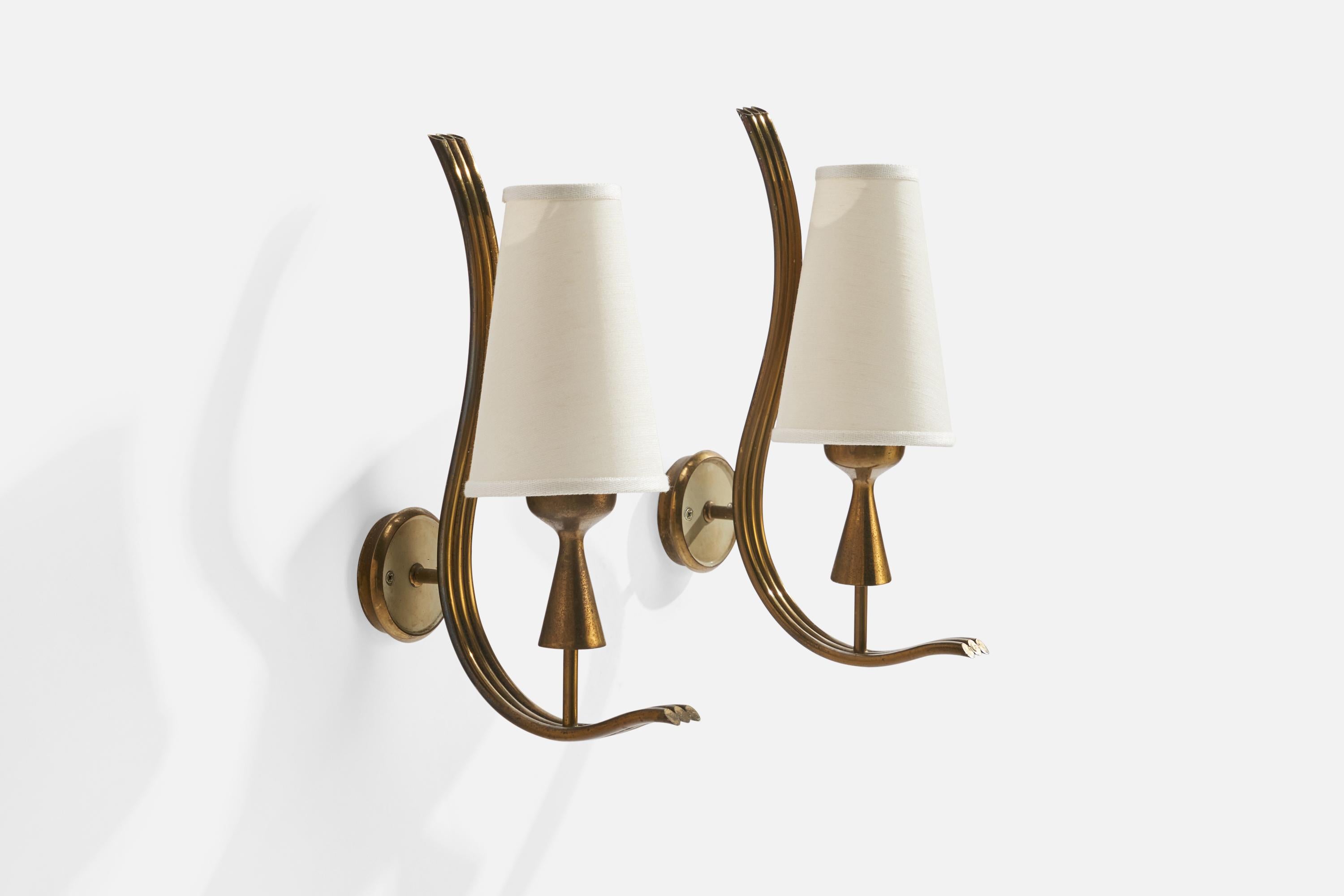 A pair of brass and white fabric wall lights designed by Angelo Lelii and produced by Arredoluce, Italy, 1950s.

Overall Dimensions (inches): 13”  H x 4” W x 7” D
Back Plate Dimensions (inches): 2.75H x 2.75” W x .75”  D
Bulb Specifications: E-14