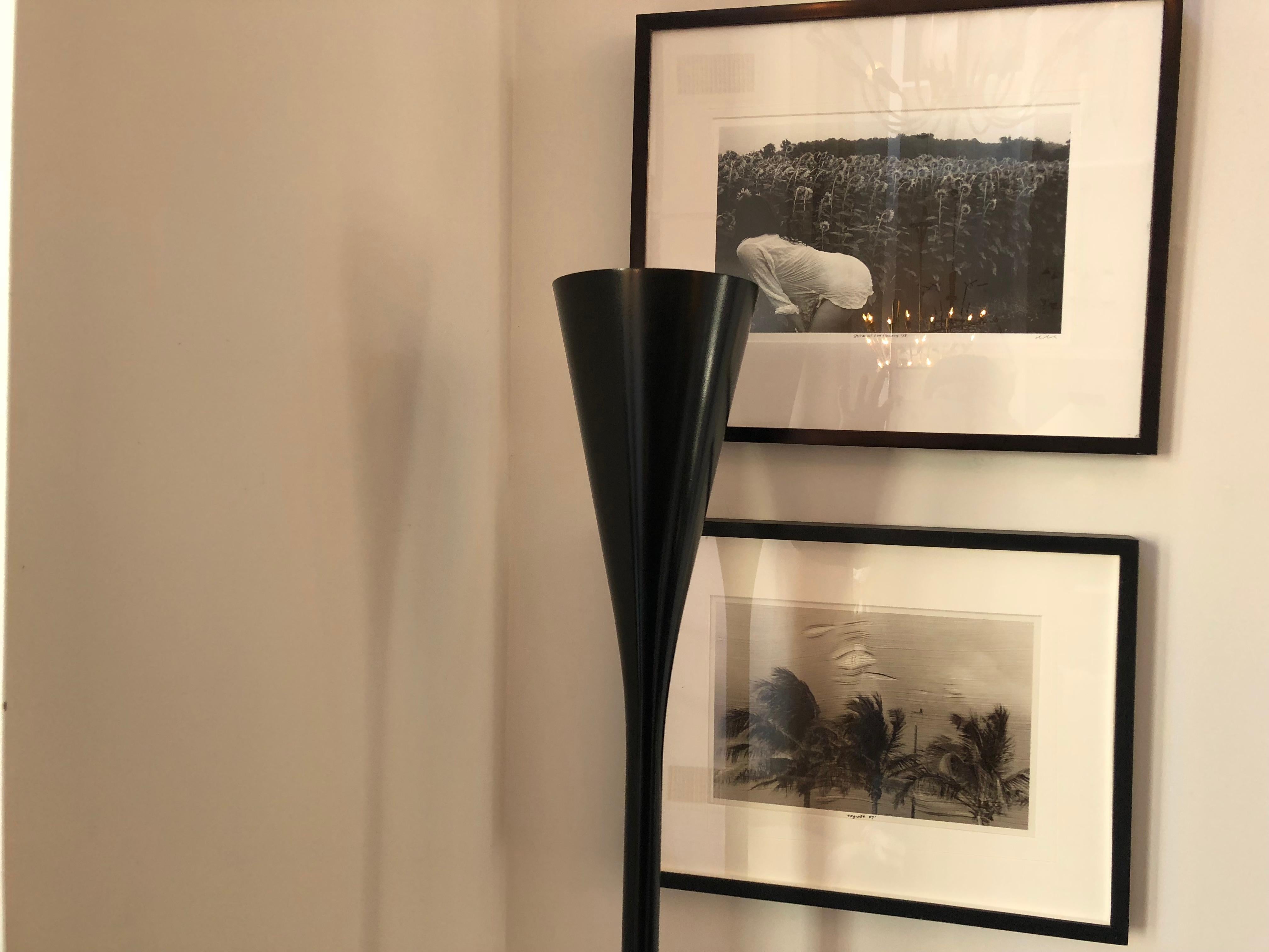 Beautiful sleek black enameled floor lamp/torchere designed by Angelo Lelli for Arredoluce. Has a white marble base and can accommodate either flood or spot light bulb. Made in Italy, circa 1960.
  
    