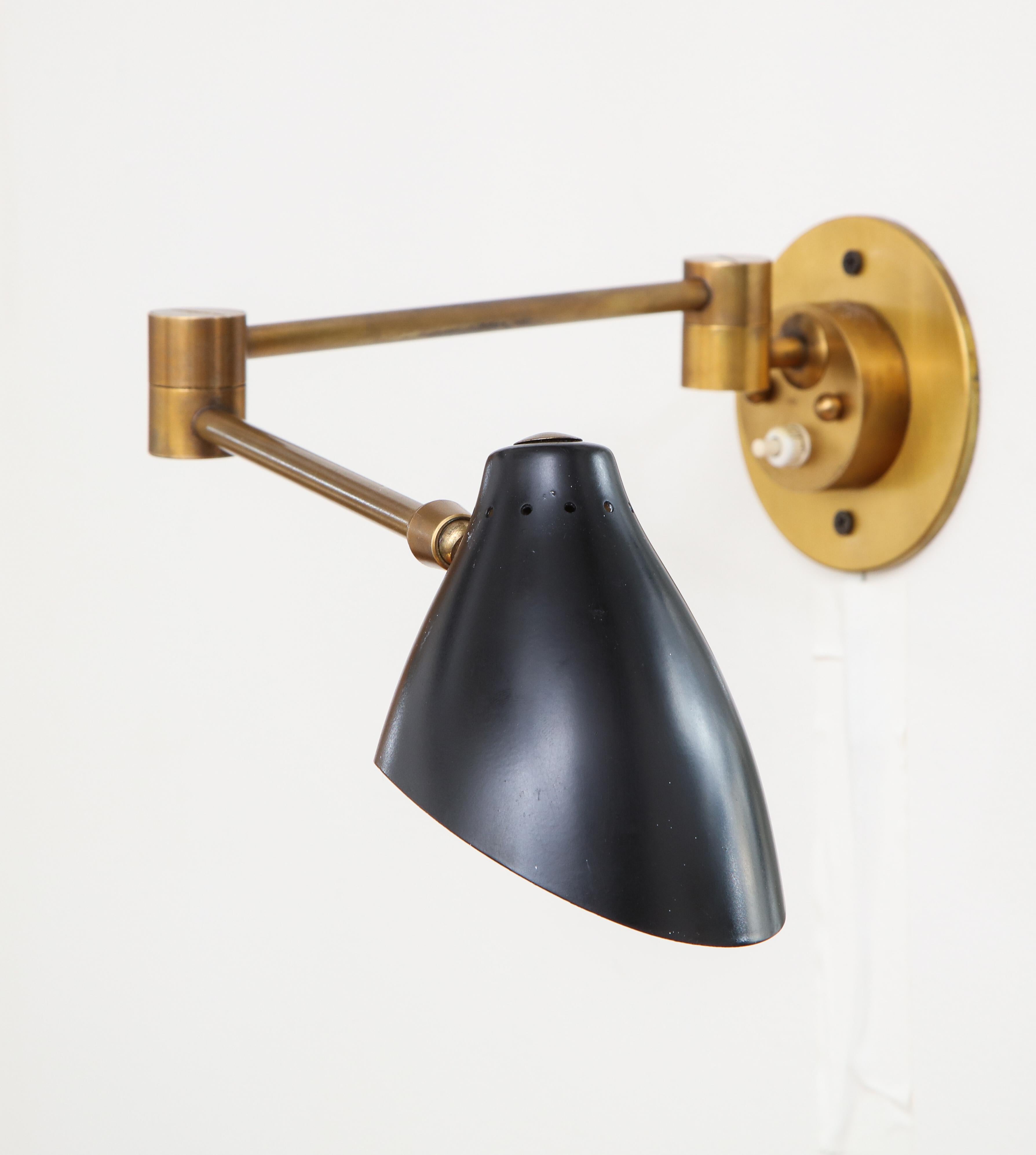 Angelo Lelii for Arredoluce rare pair of articulating sconces with pivoting lacquer aluminum shades on triple joint structure in brass adjustable to various positions. These sconces have a simple and elegant design and are made with expert