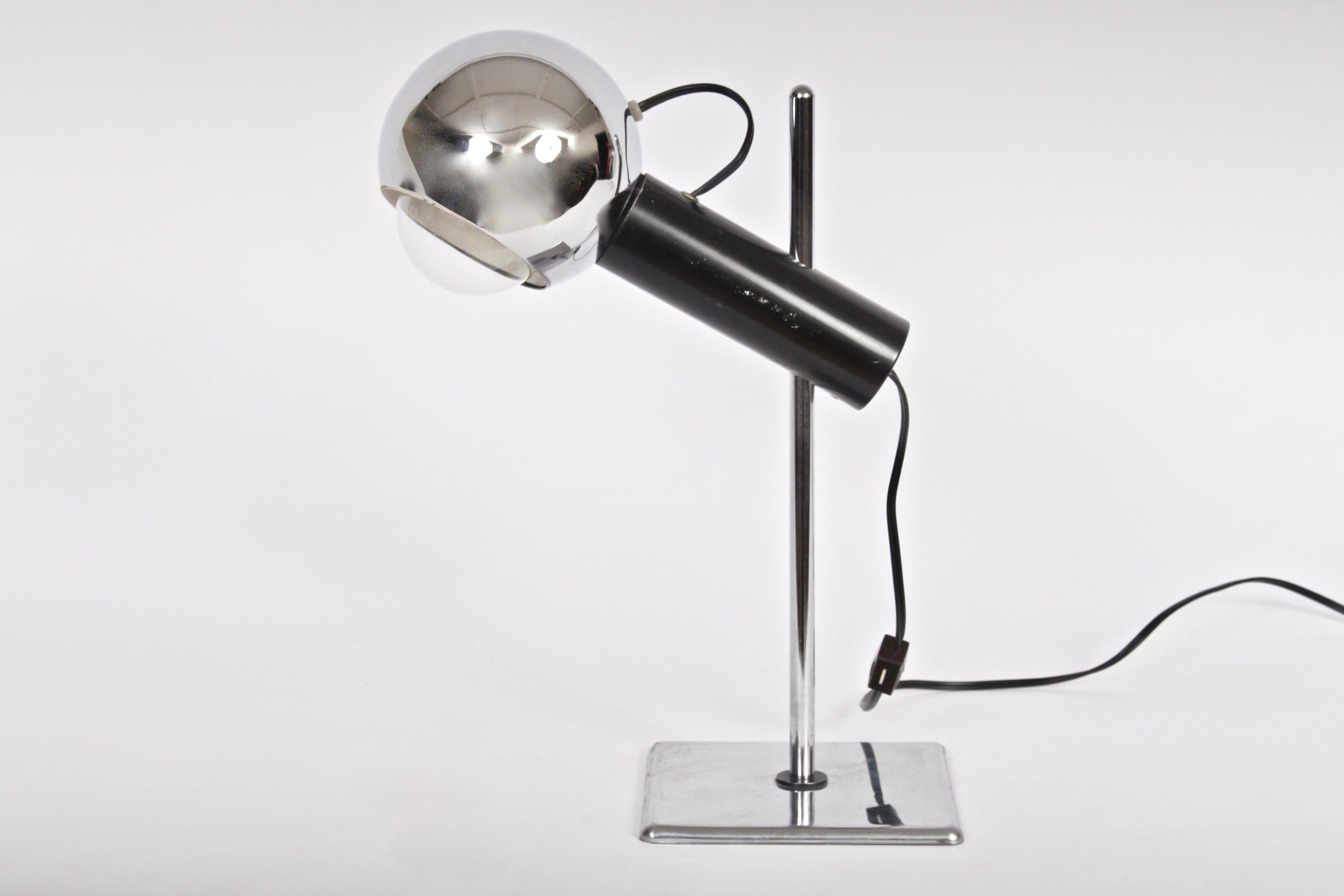 Angelo Lelli style adjustable magnetic chrome reading lamp, bedside lamp with chrome swivel eyeball shade. 1960's. Featuring a black magnetic arm bar, 5D chrome ball shade adjusting 360 degrees, interior liner shade, adjustable chrome stem (stem