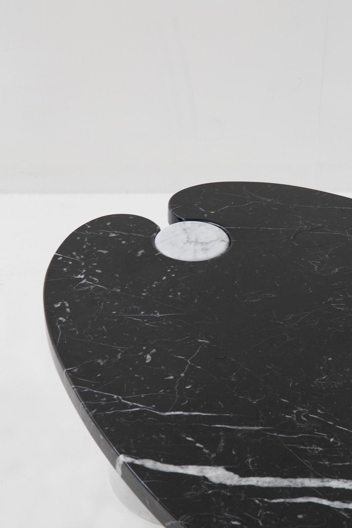Oval coffee table by Angelo Mangiarotti 1970s with Skipper label in black and white marble. The coffee table was designed and made with two different types of marble. For the two conical-shaped pedestals a white marble is presented, while for its