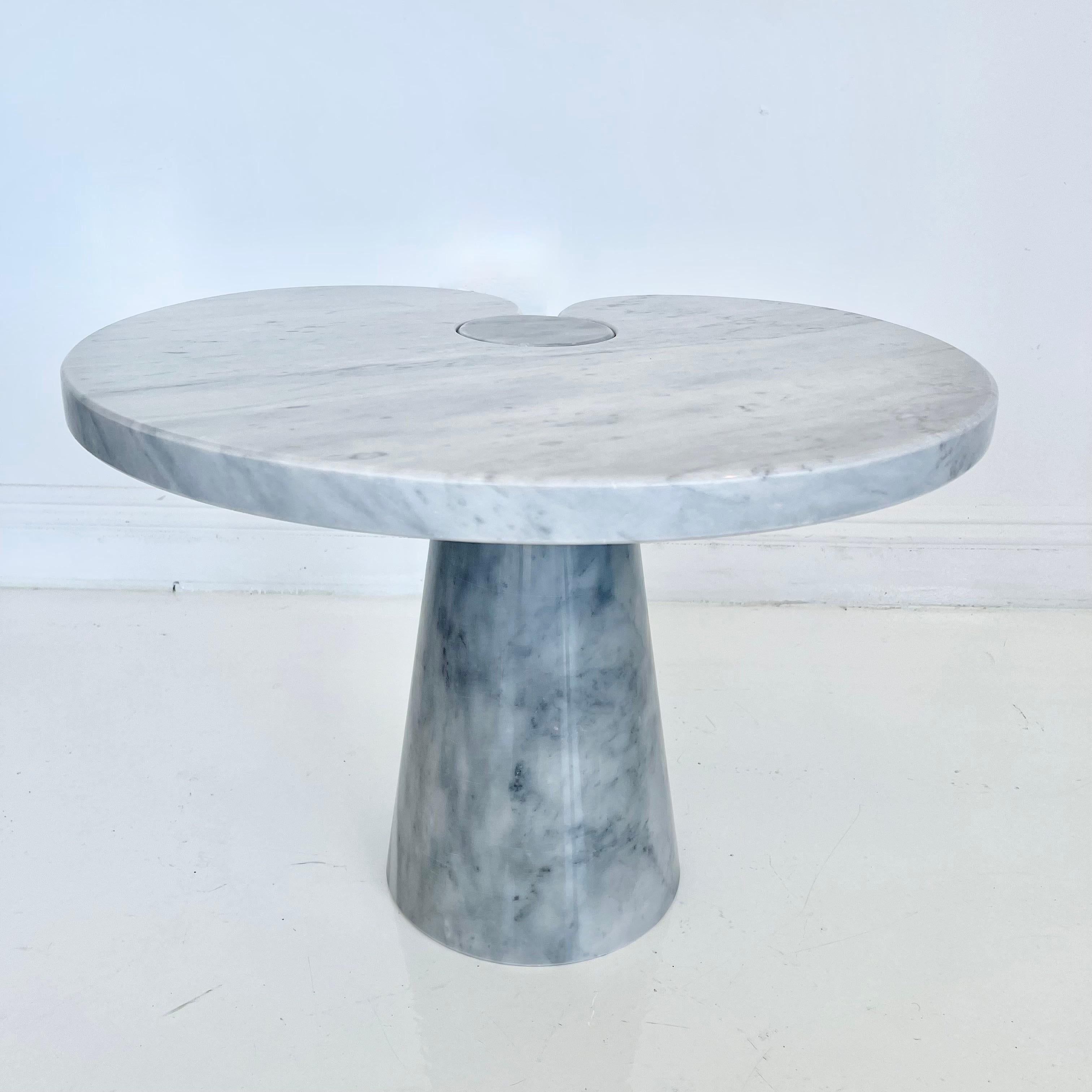 Stunning Carrara marble side table designed by Angelo Mangiarotti for Skipper in the 1970s. Large cone shaped base holds a large water lily shaped slab of marble with a circular cut out which fits around the top of the base. Extremely heavy and well