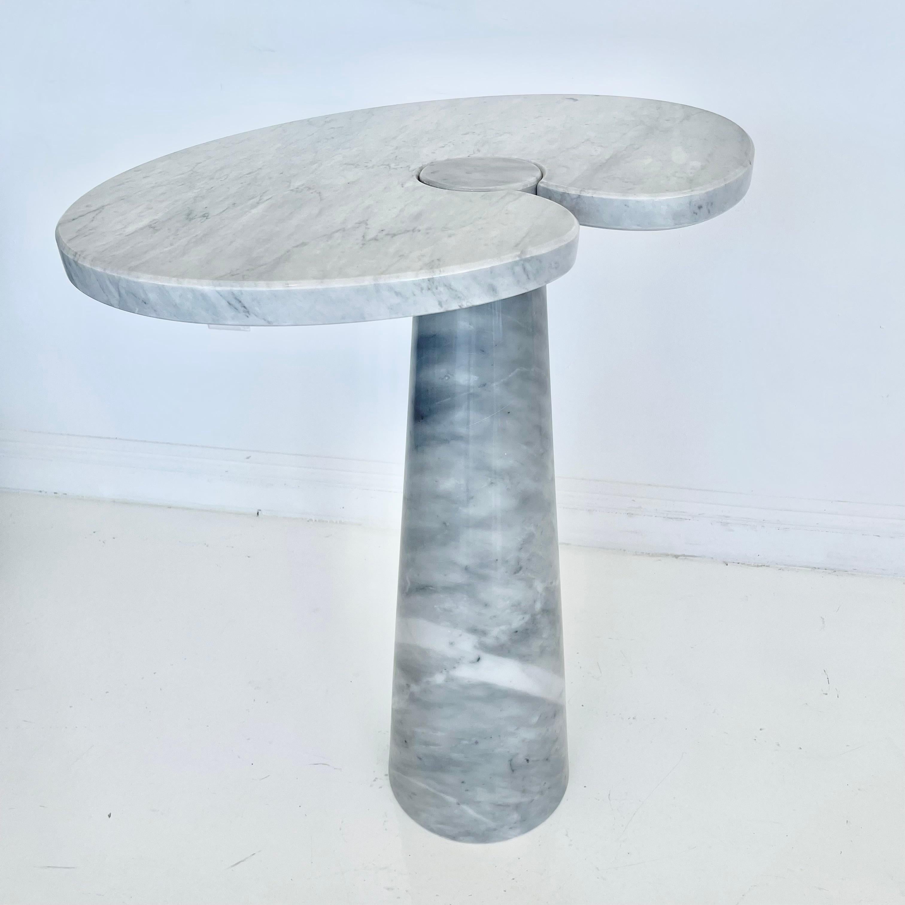 Stunning Carrara marble side table by Angelo Mangiarotti. Large cone shaped base holds a large water lily shaped slab of marble with a circular cut out that fits snugly around the top of base. Extremely heavy and well made. White and blue/grey veins