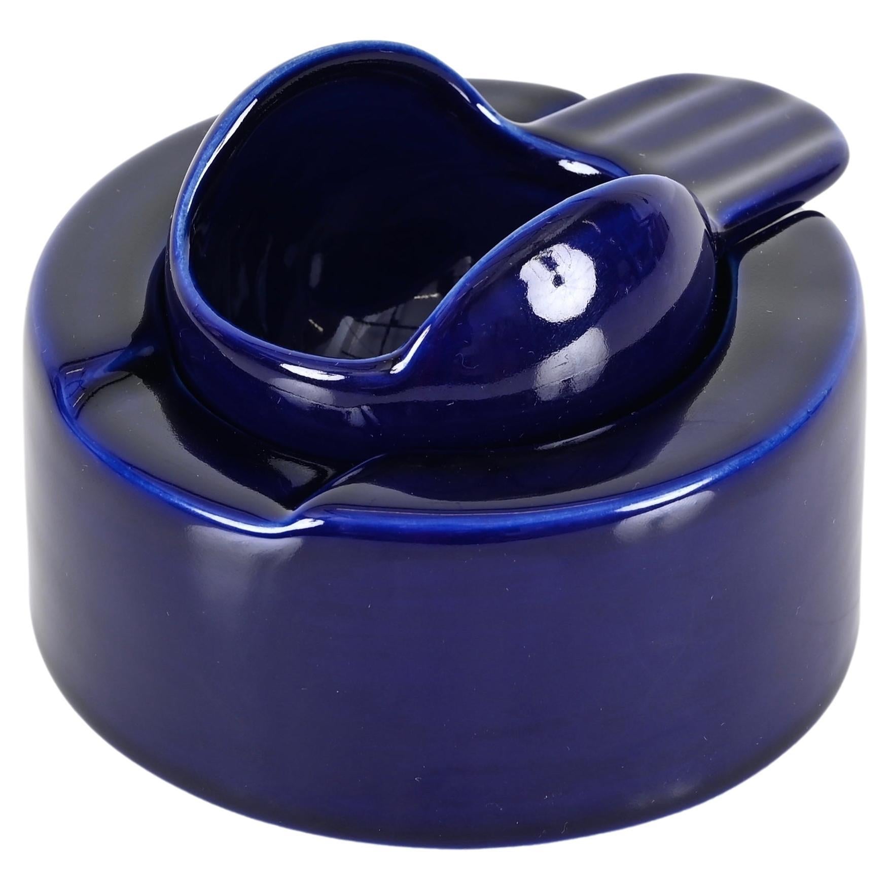 Stunning cobalt blue ceramic ashtray designed by Angelo Mangiarotti and produced by Frateklli Brambilla in Italy in the 1970s.

This gorgeous two piece ashtray features a top that can rotate over the base to close or open the ashtray. The quality of