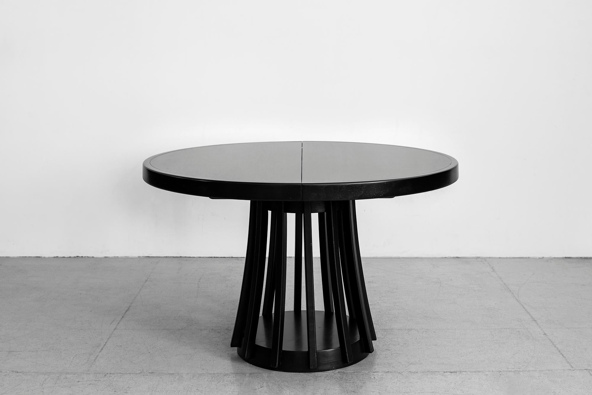 An extendable dining table by Angelo Mangiarotti manufactured by La Sorgente Dei Mobili, 1972.
Rosewood, extendable tabletop, professionally refinished in ebony. 
Extension mechanism folds the leaf out from underneath center of table.