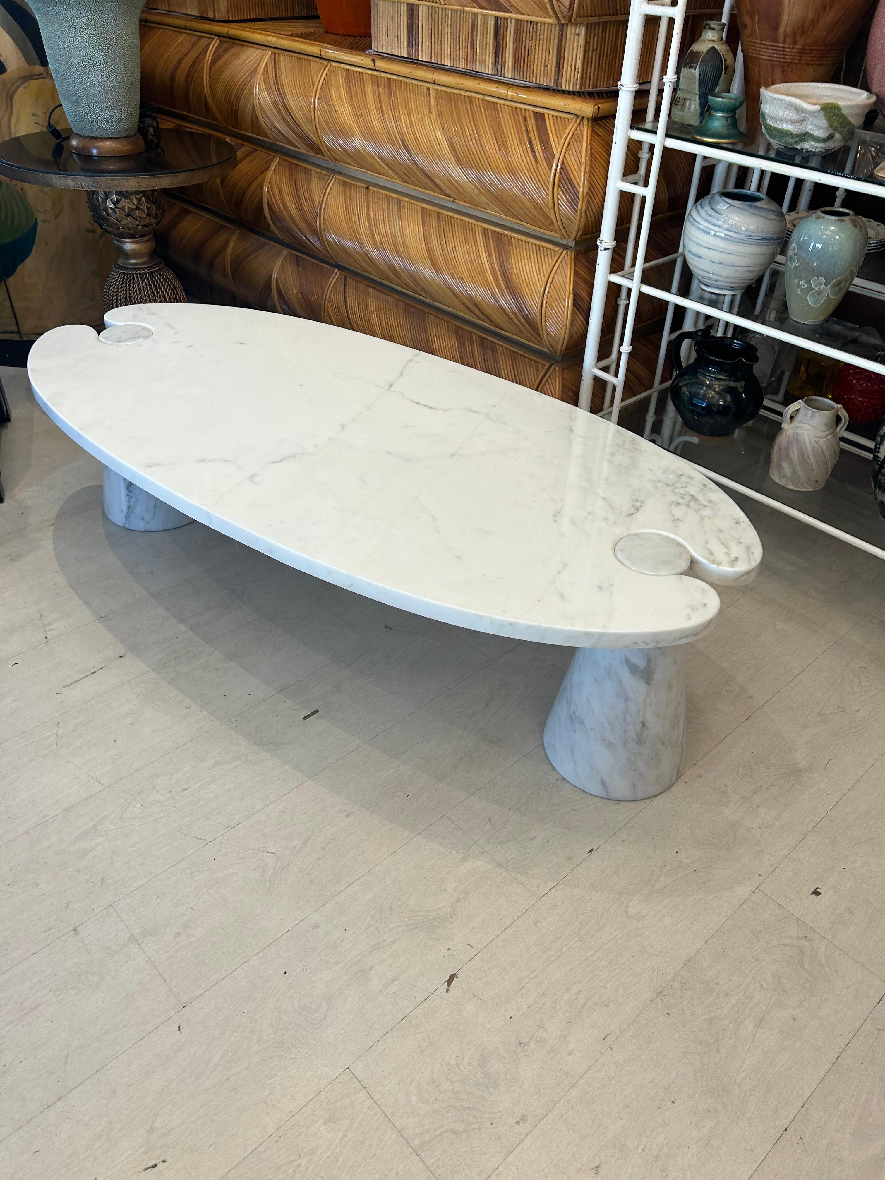 Angelo Mangiarotti Eros  Carrera marble coffee table.55x25.5x15.75 inches.. Beautiful oval shape with the two cone shaped marble bases, supporting the top with the unique Mangiarotti Eros style .. The marble is in very good condition no stains no