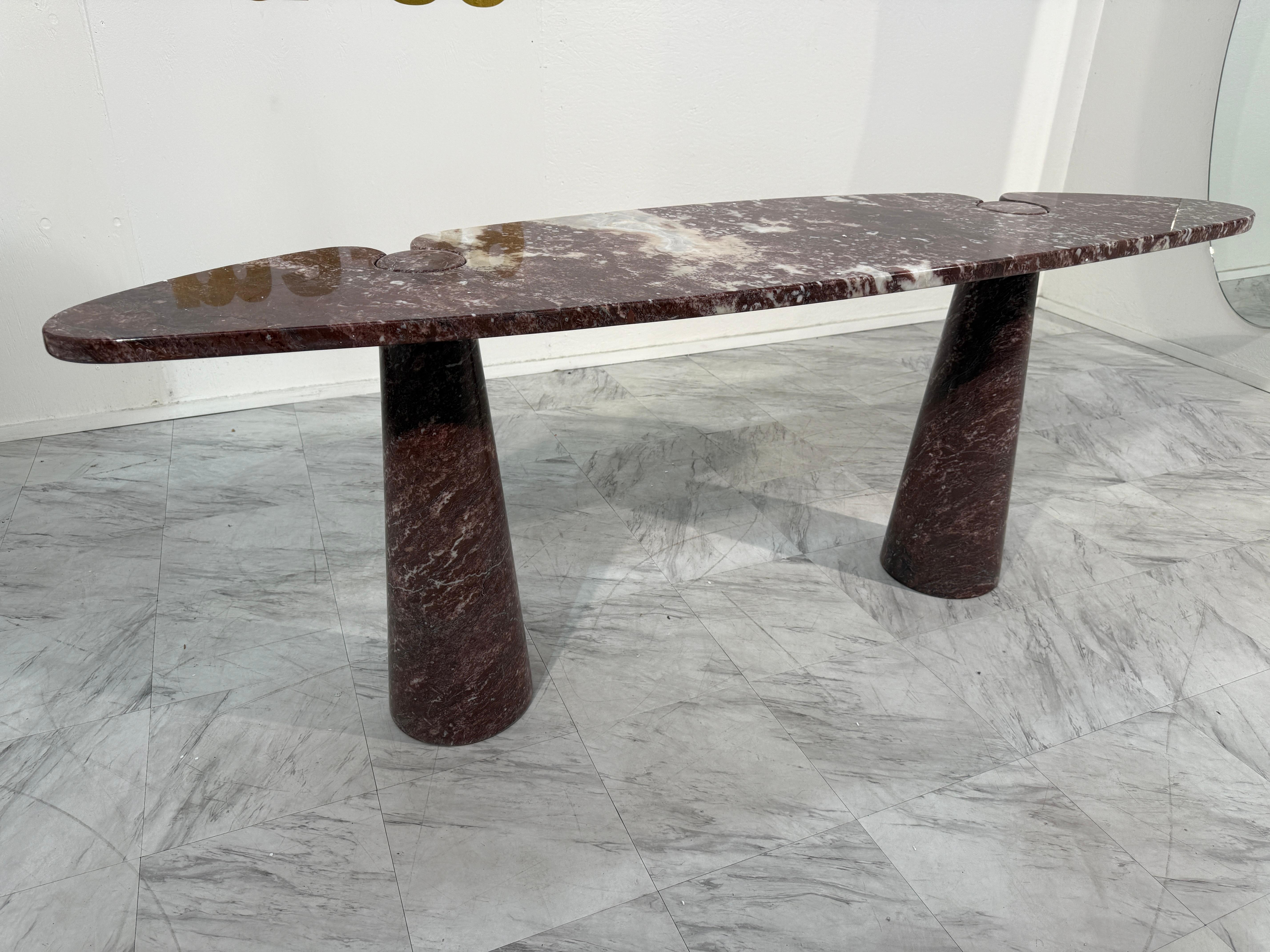 Rare “Eros” console table designed by Angelo Mangiarotti in the 1970s, executed in striking Rosso Verona marble.

This sculptural piece belongs to Mangiarotti’s renowned Eros series, celebrated for its ingenious construction method: the oval top