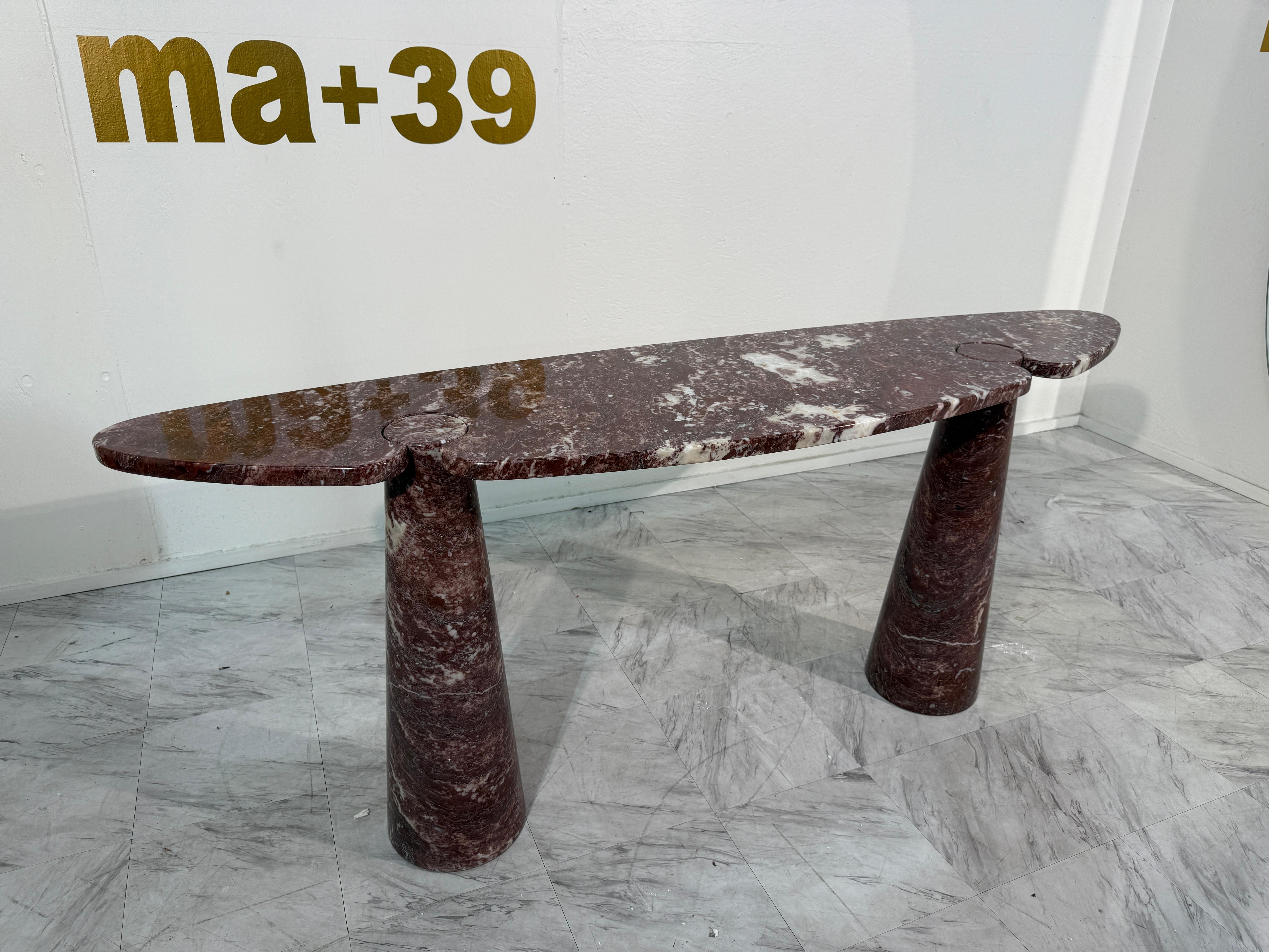Rare “Eros” console table designed by Angelo Mangiarotti in the 1970s, executed in striking Rosso Verona marble.

This sculptural piece belongs to Mangiarotti’s renowned Eros series, celebrated for its ingenious construction method: the oval top