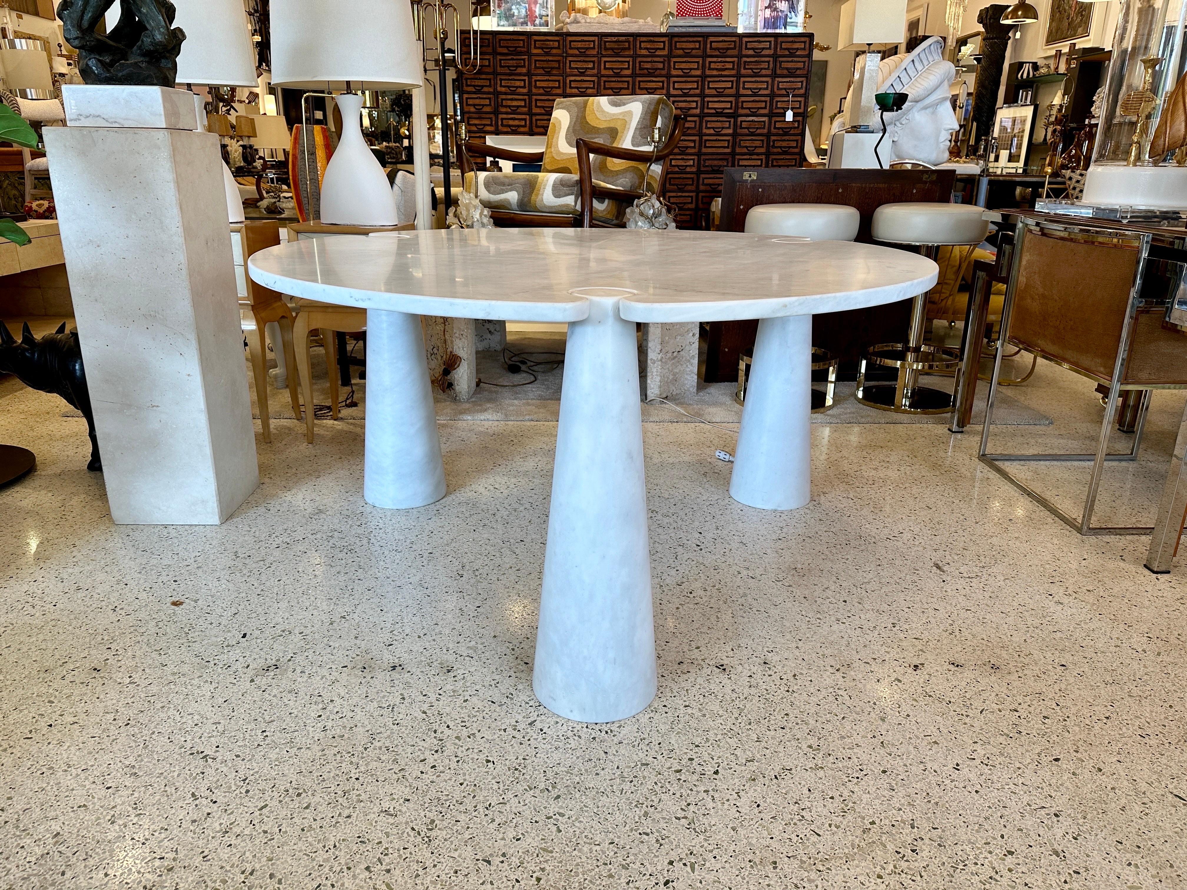 Angelo Mangiarotti, dining table ‘Eros’, round, white marble, the 1970s.  This sculptural table by Angelo Mangiarotti is a skillful example of postmodern design. The table is executed in white marble. The tabletop features no joints or clamps and is