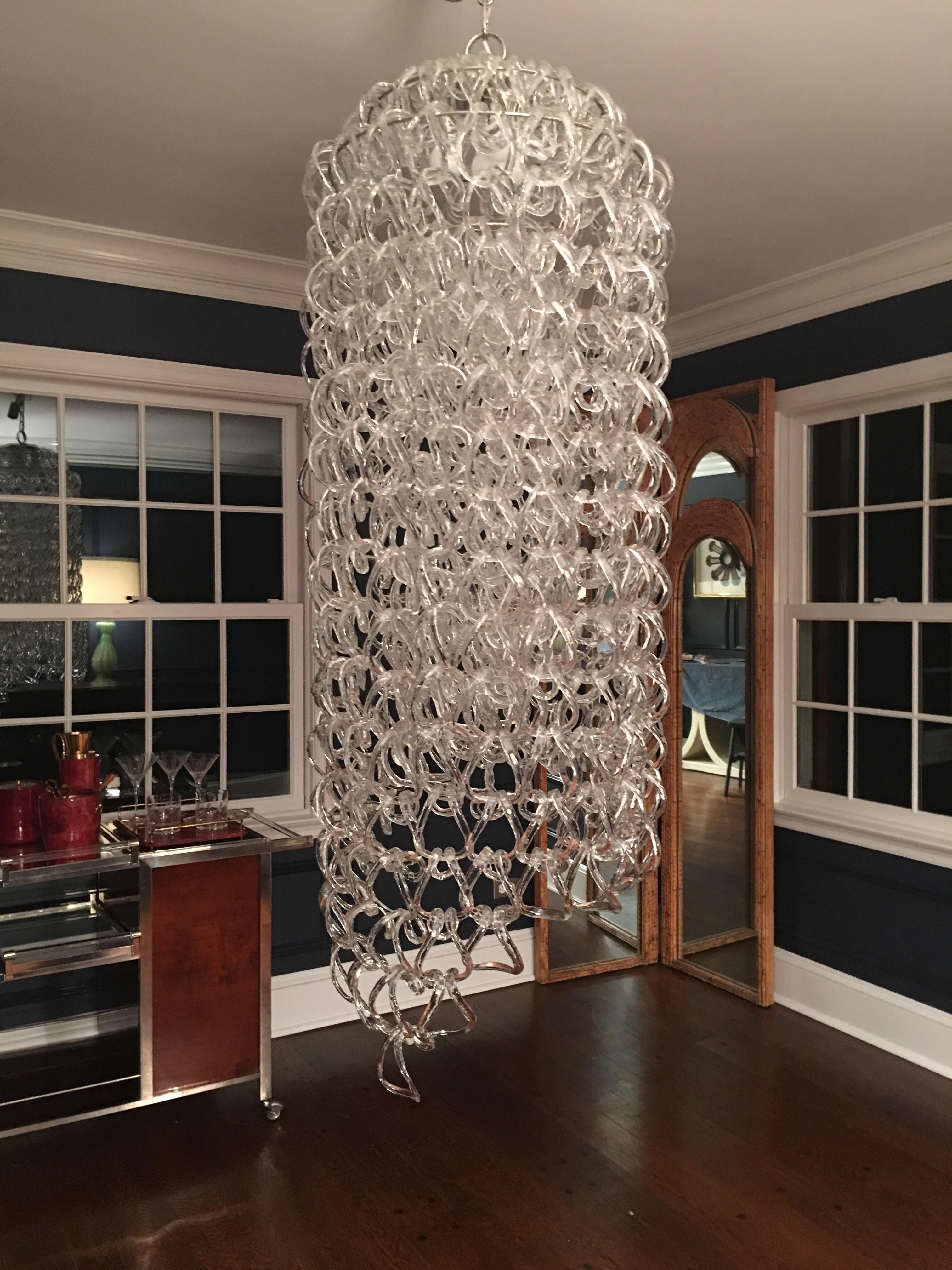 Original large Angelo Mangiarotti for Vistosi 'Giogali' chandelier circa 1970 made with over 400 Murano handmade glass links in double horseshoe rings, suspended by tiered metal frame, Italy, c. 1970.  Truly elegant design of cascading links that