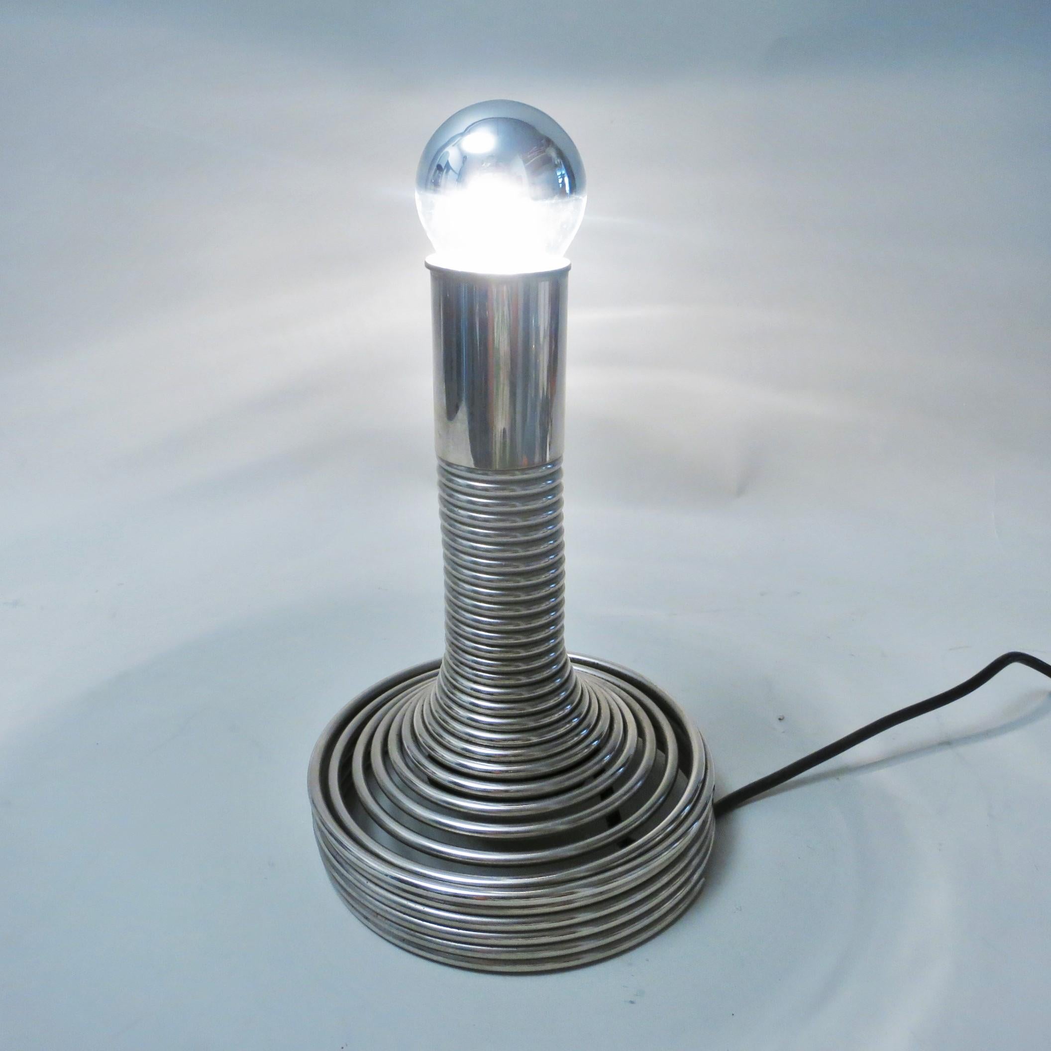 Spirale table lamp designed by Angelo Mangiarotti, Italy, circa 1970 and manufactured by Candle, Milano. The “Spiral” table light is made of a chromed steel spring with a hidden and integrated switch inside the bouncing base.
        