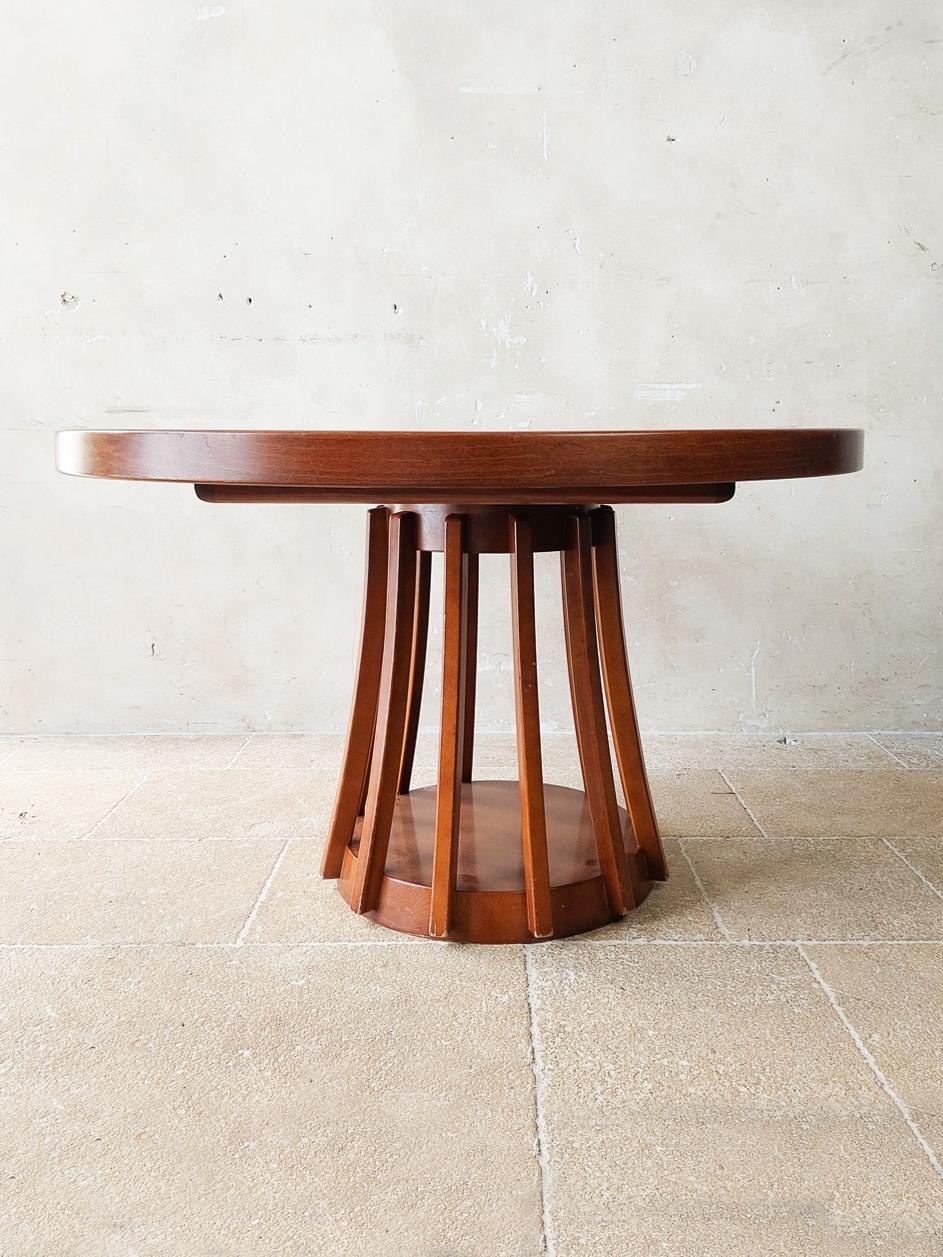 Angelo Mangiarotti mahogany dining table for La Sorgente dei Mobili, Italy, 1972. An extendable round mahogany table with a round ‘lamella’ base with an open structure. This creates a nice contrast with the solid and heavy table top. The round table