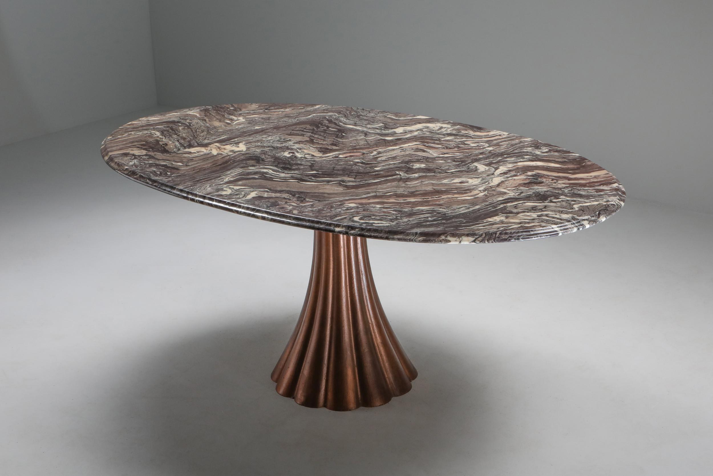 Oval marble dining table on copper patinated cast base, attributed to Angelo Mangiarotti, Italy, 1970s
Postmodern piece with stunning decorative qualities.
The marble seems to move in a Missoni wave pattern, add this to the copper patinated cast
