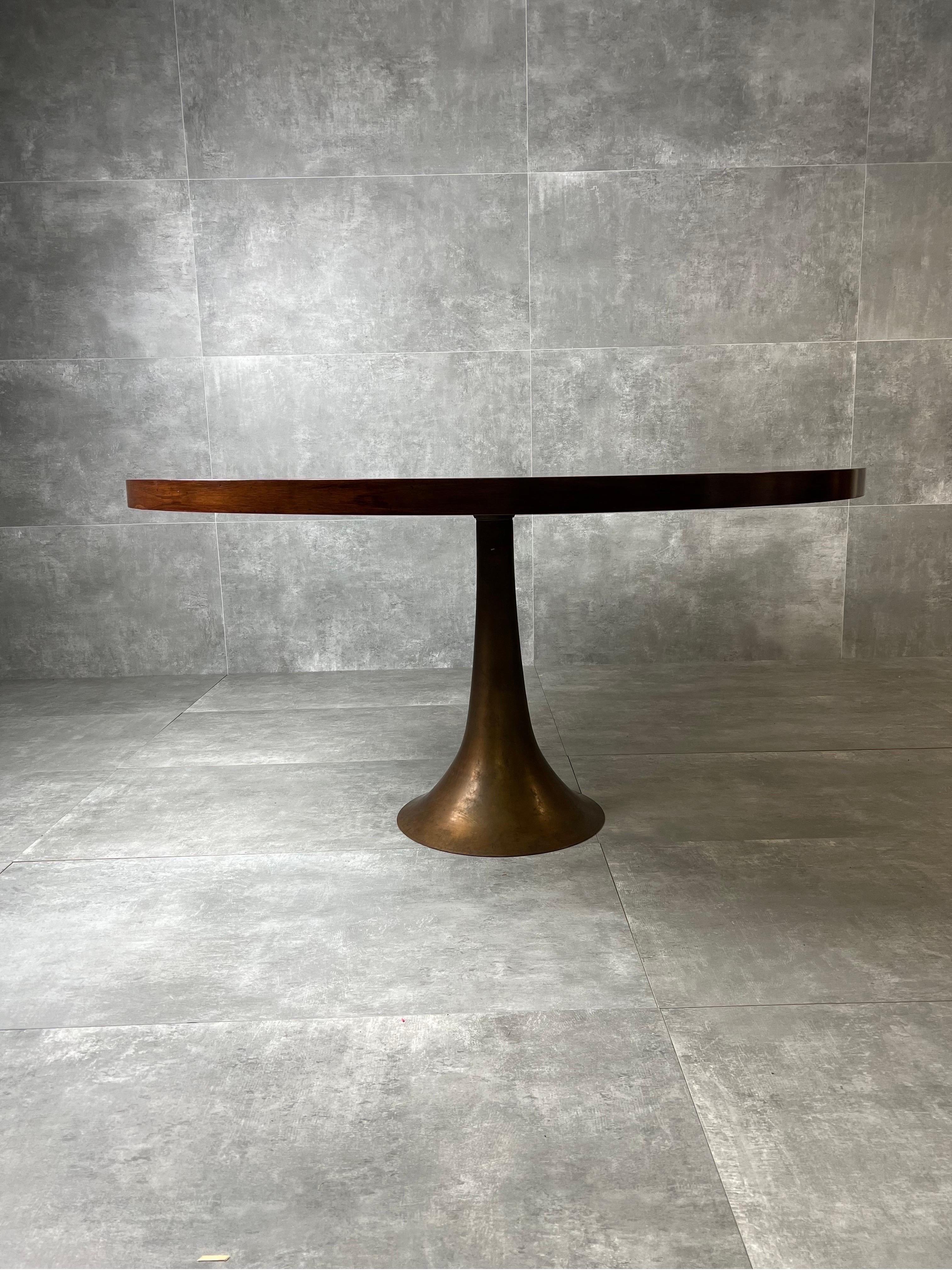 Table model 302 cast bronze finished on a lathe and wood floor designed by Angelo Mangiarotti and produced by Bernini in 1959.