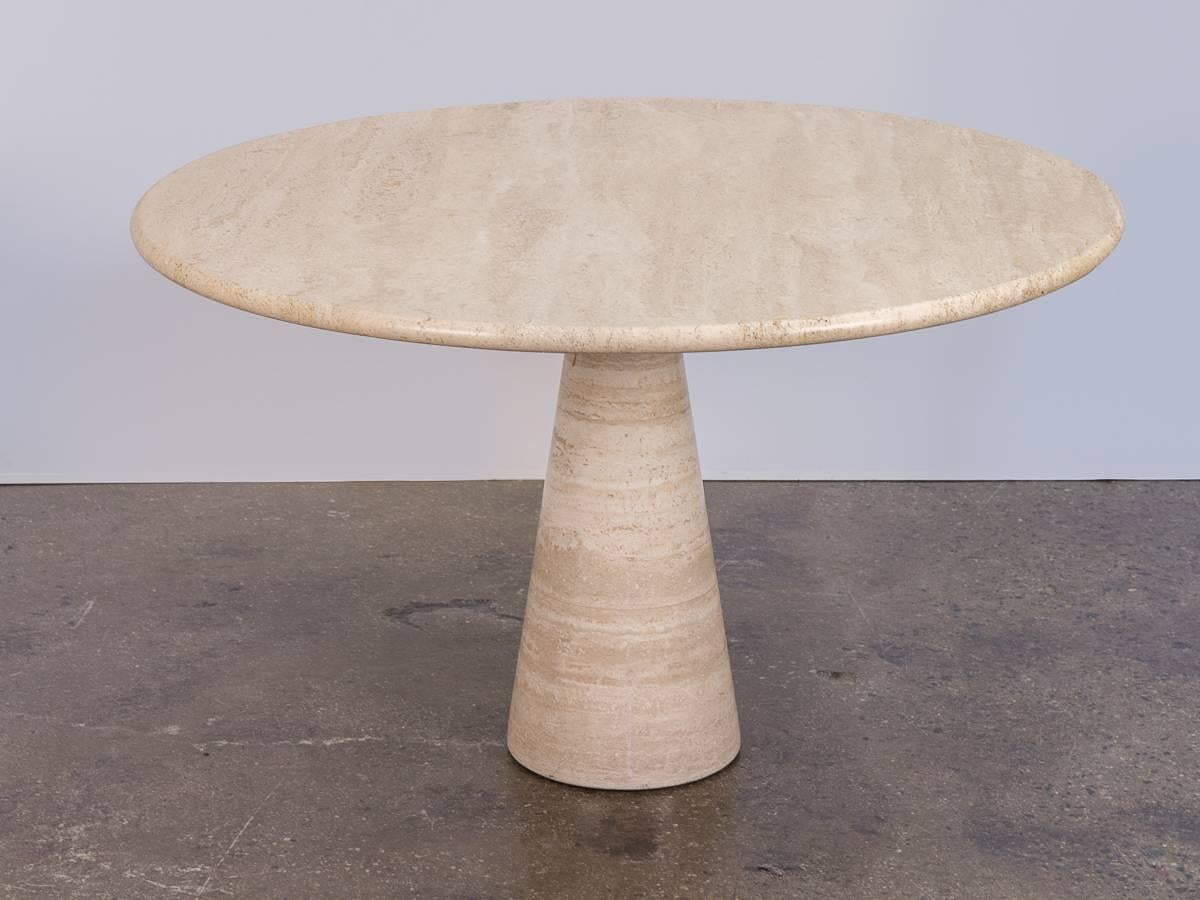 Impressive travertine table designed by Angelo Mangiarotti. The marvel of this Italian table design is the top balances perfectly and securely by it's own weight. The travertine has beautiful striations running throughout, there are no chips or