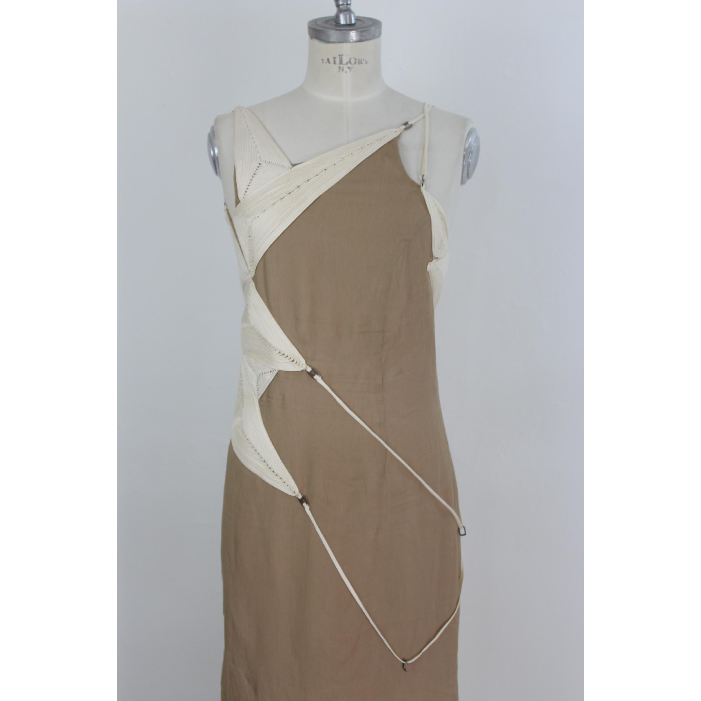 Long evening dress designed by the Italian fashion designer Angelo Mozzillo. It is 100% silk, beige. It is characterized by a corset sewn in relief. It behind the shoulder has a beautiful weave of customizable laces. Unique in its kind. Excellent