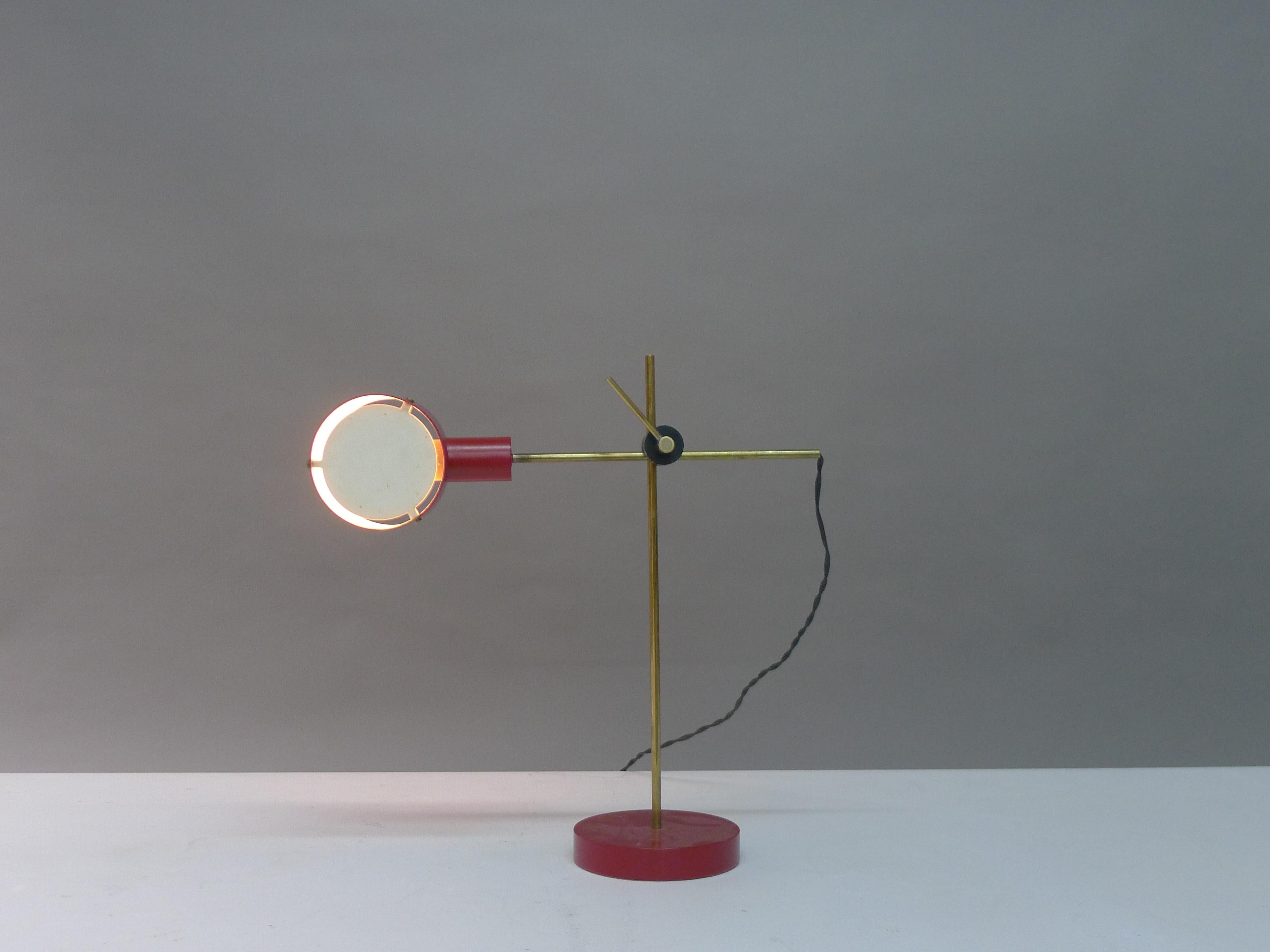 Angelo Ostuni , Renarto Forti & Giuseppe Ostuni , model 259 for Oluce , Italy , 1958 . Table or desk lamp of a very simple design yet so effective in terms of adaptability . A single lever at the point of intersection in the two brass rods allows