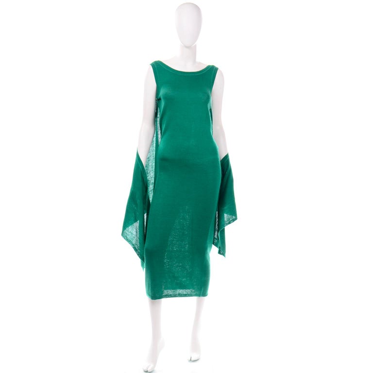 This fun green stretch knit vintage Angelo Tarlazzi dress is so incredibly versatile! The dress is in an emerald green stretch knit with ribbed edges similar to tee-shirt styling and we especially love the draped fabric panel that can be worn in a