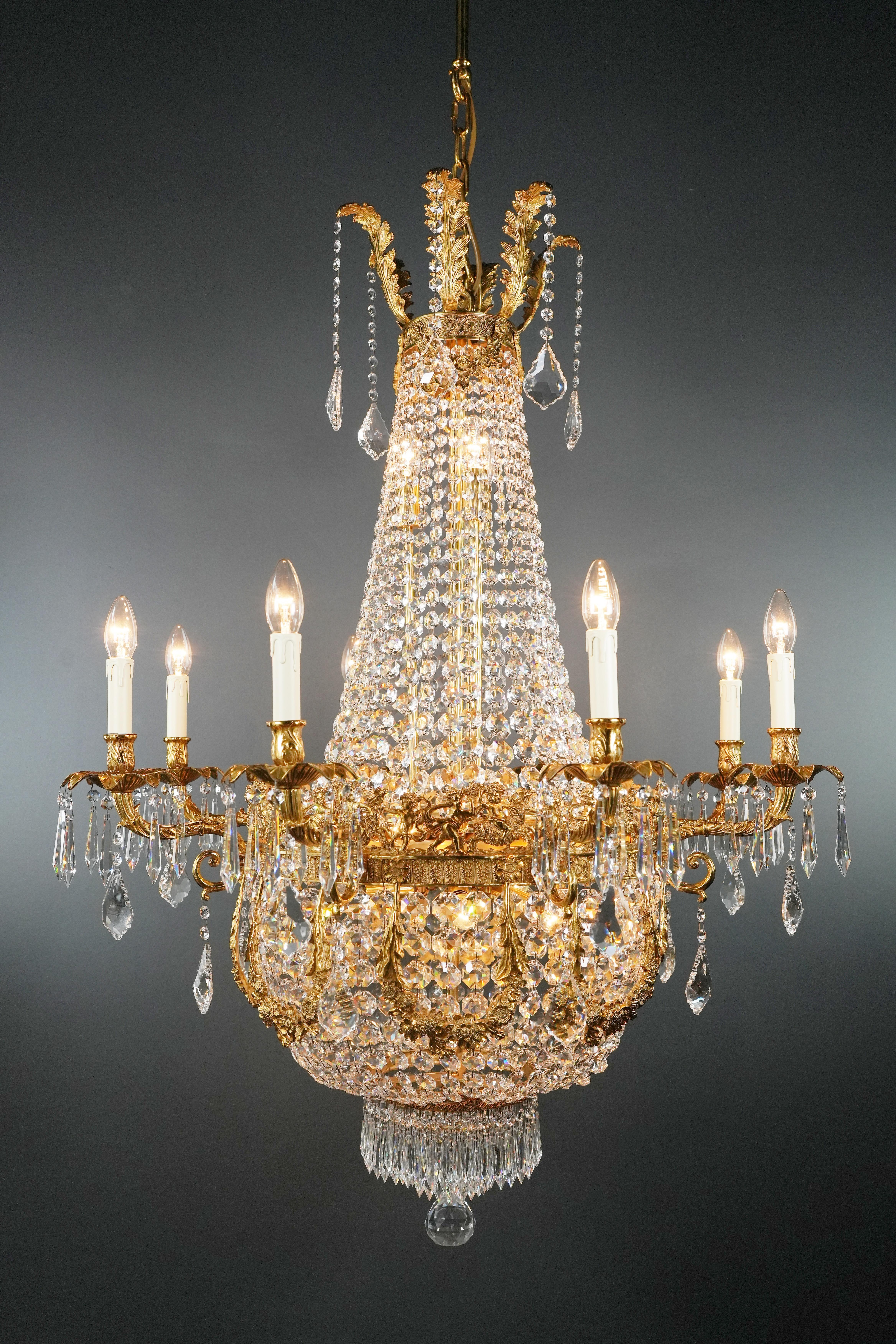 Introducing a stunning Brass Basket Empire Sac a Pearl Chandelier, an exquisite piece adorned with captivating crystals, reminiscent of the classical style of the Empire era. This is a new reproduction, and several are available, ensuring you can