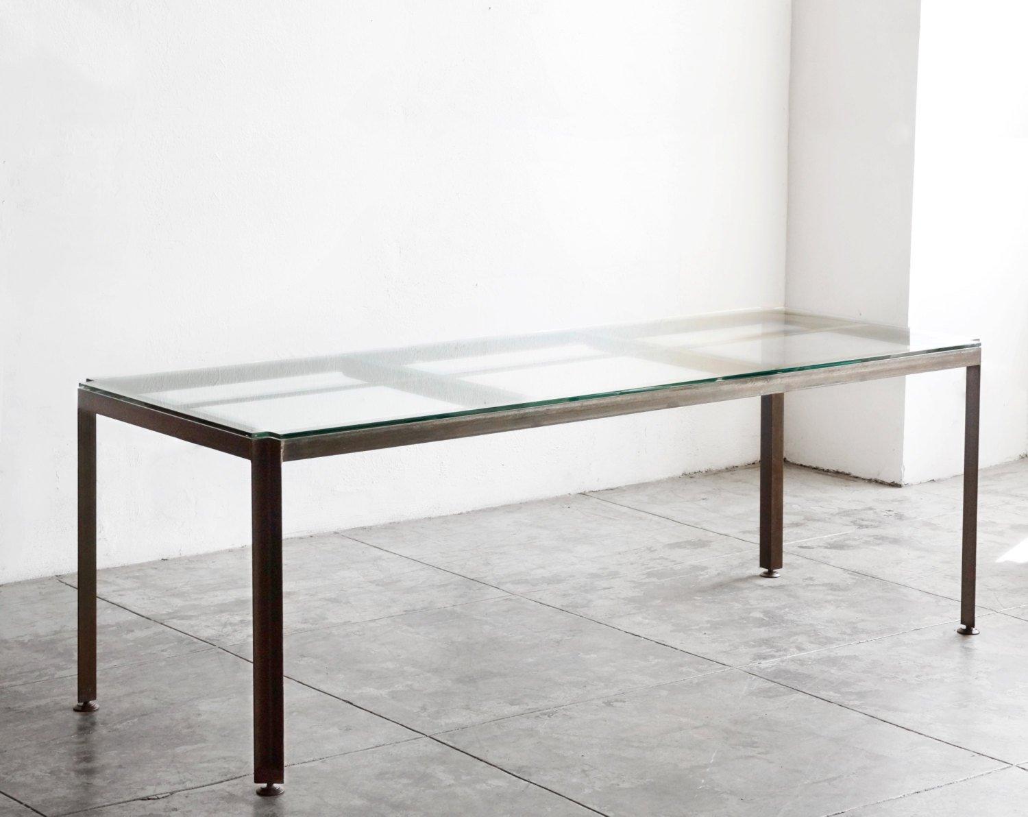 Outstanding Industrial-style table made exclusively by Rehab vintage Los Angeles. Composed of heavy duty angle iron treated with a patina finish. Half-inch tempered glass top with unique angled corners reveals the frame's elegant spine. Ideal for