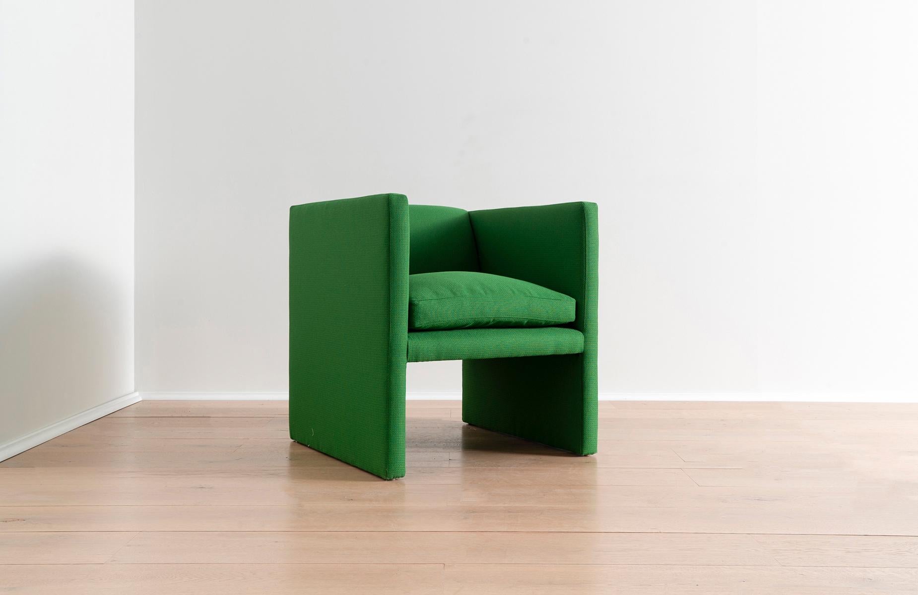 Incorporate this upholstered green lounge chair in your living room, or as a bold addition to a dining table or desk. Simple, striking, and deceptively comfortable despite its slender profile, this chair combines an appreciation for elegant, yet