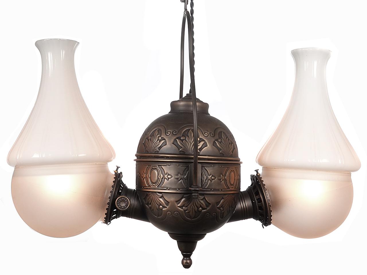 This style of double kerosene hanging lamp was popular in stores because it cast more light downward, and has been electrified. Signed, Angle Mfg., NY, this picturesque antique 1890's light has original glass and chimneys. The look of this lamp is