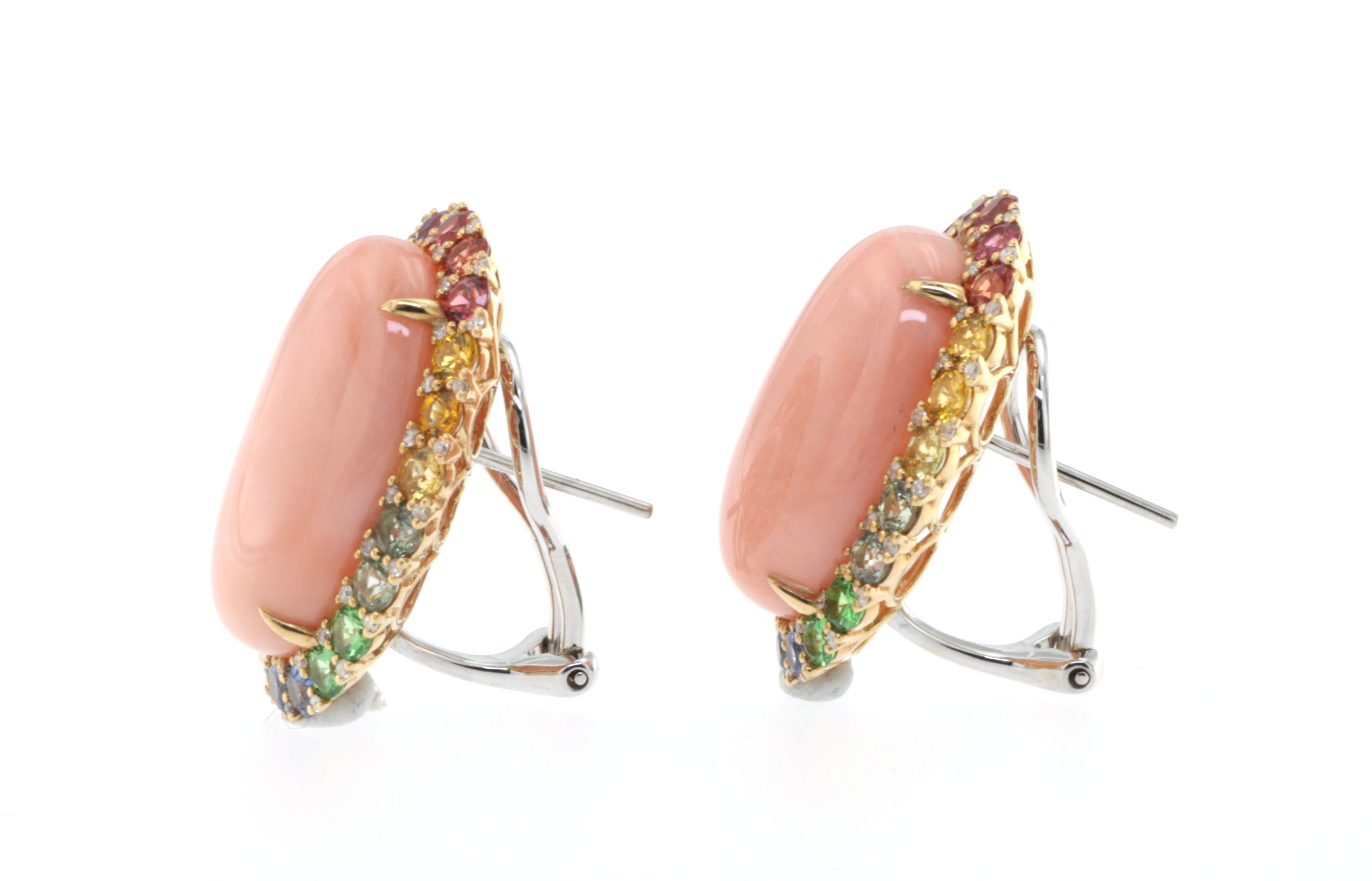 Introducing a dazzling pair of earrings that encapsulate timeless elegance and vibrant allure. At the heart of this masterpiece lies a striking 37.85 carats of angel skin coral, known for its delicate hue that gracefully captures the essence of